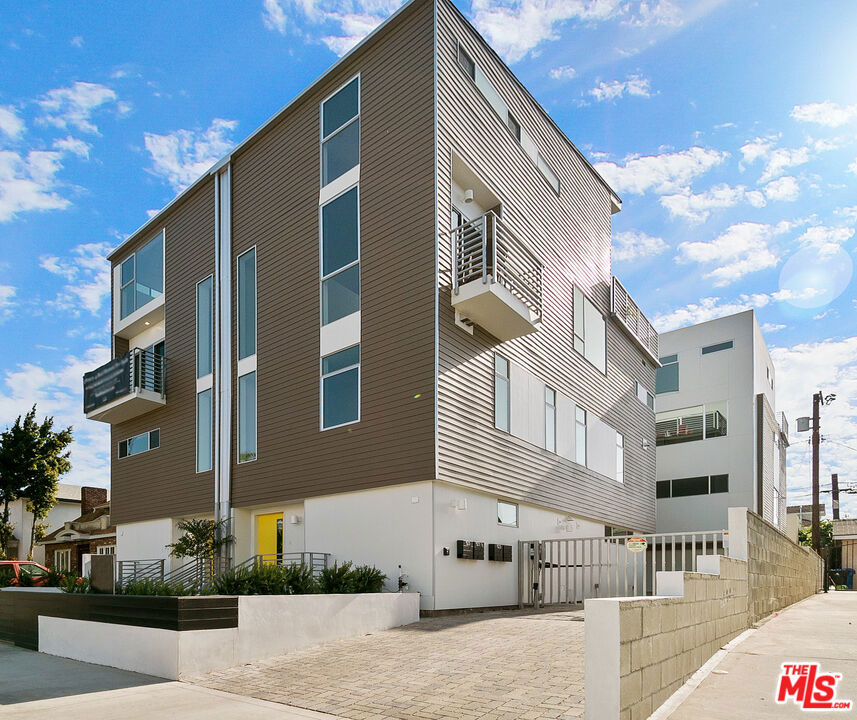 The Wilton Court is an intimate community of four homes built in 2020, located in the sought-after Third Street School District of Hancock Park. This residence offers over 1,780 square feet of modern living space, along with a two-car tandem garage equipped with an EV charger.The second floor includes a primary suite with a large walk-in closet and a spa-like bathroom, plus a second en suite bedroom. The third floor features an open living and dining area with a balcony that offers hillside and Griffith Observatory views.The kitchen includes a breakfast bar, pantry, dumbwaiter, and Samsung appliances. The top floor has a guest bedroom, full bath, and a flexible space ideal for a home office or den with views of the Hollywood Sign.A private rooftop deck with a built-in BBQ and sink provides city and sunset viewsgreat for relaxing or entertaining. Additional features include built-in speakers on the main level and rooftop, a gated driveway, and a tankless water heater.Conveniently located near Larchmont Village.