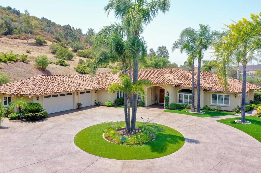 Nestled behind the gates of Lake Vista Estates, sits this immaculate single story Mediterranean home. The paved circular driveway and beautiful landscaping welcomes you to this private estate. Sitting on 2.6 acres of land, landscaped and partial fencing. Fully paid for Solar/ Power Wall Battery, and a Tesla charging station. Walk through the large double doors you enter a warm foyer that leads to an open floor plan with high ceilings, Large Windows, fireplaces, and a view of the outdoor pool area. This home hosts four bedrooms and four bathrooms, a gourmet kitchen, large family room and eating area, a formal dinning room and formal living room. 2 Beautiful brick fireplaces for those cold winter nights. The private patio has a covered seating area with an outdoor TV, fire pit table, outdoor cooking and an inviting pool and spa . Enjoy the sunsets and cool ocean breezes, overlooking the San Luis Rey Valley, located only about 14 miles from the Pacific Ocean.