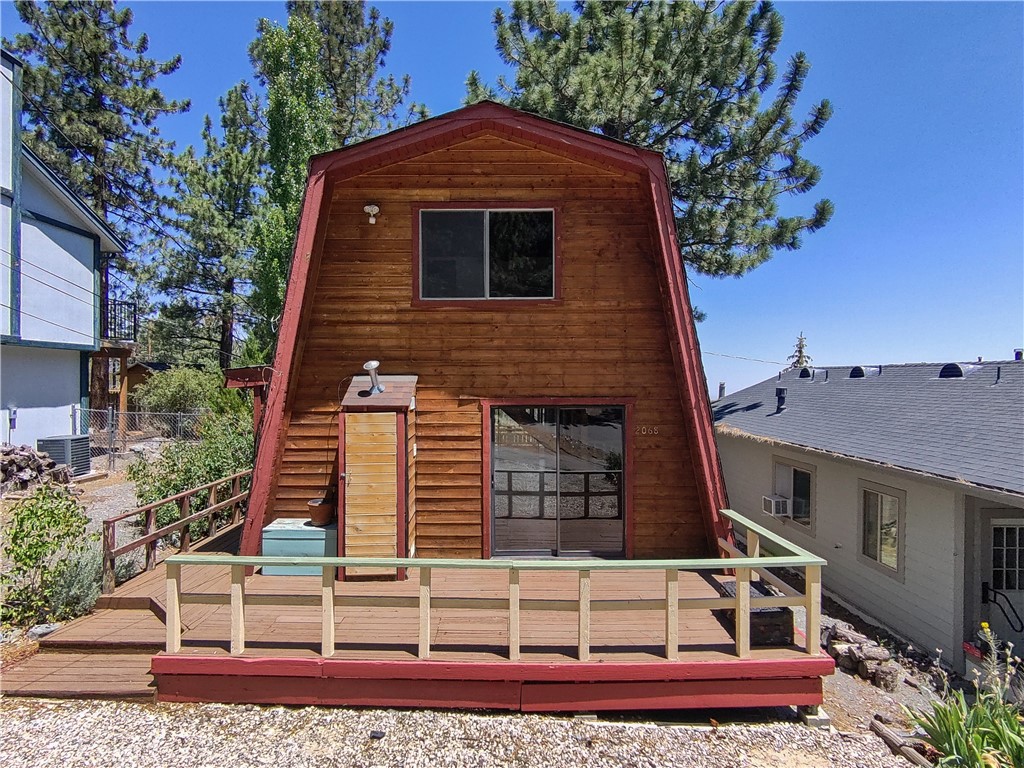 Welcome to 2068 Slippery Elm Rd, a stunning Gambrel Style Home nestled on the East Side of Wrightwood. This iconic mountain retreat offers the perfect blend of rustic charm and modern comfort, ideal for a weekend getaway or year-round living.
Perched among majestic trees, this property boasts breathtaking views of the high desert, creating a serene and awe-inspiring backdrop for your daily life. The flat lot provides ample parking and versatile outdoor space, limited only by your imagination.
Expansive front and rear decks seamlessly connect indoor and outdoor living, allowing you to fully embrace the mountain lifestyle. Step inside, and you'll be greeted by a spacious living room centered around a cozy fireplace, setting the tone for this exquisite home.
The well-appointed kitchen serves as a natural divide between the living room and dining area, perfect for entertaining or intimate family gatherings. Modern conveniences abound, including an indoor laundry room with complimentary appliances.
Indulge in the full bath's soaking tub, offering a luxurious retreat after a day of mountain adventures. Sliding doors at both the front and back of the home invite the crisp mountain air inside, while natural light floods the interior, bringing the outside in.
Ascend the beautifully crafted stairs to discover two lofty bedrooms on the upper level. The primary bedroom is a true highlight, featuring an elevated deck that showcases the desert panorama in all its glory.
With its prime location, 2068 Slippery Elm Rd offers the best of Wrightwood living. Surrounded by the soothing sounds of whispering pines and bathed in natural light, this home truly captures the essence of mountain living. Don't miss this opportunity to own a piece of Wrightwood paradise!