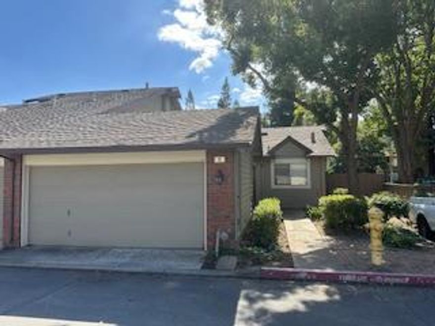Dont miss this incredible opportunity to own a spacious, single-level 2 bed, 2 bath home with an attached 2-car garage in a well-maintained and desirable complex! This end unit offers privacy and a generous back and side yard, giving it the feel of a single-family home with the ease of low-maintenance condo living. Step inside to soaring vaulted ceilings in both the living room and primary suite, creating an open, airy atmosphere. The kitchen features beautiful, real wood cabinetry, abundant counter space, and excellent natural lightperfect for cooking and entertaining. The attached 2-car garage includes ample built-in storage shelving, providing plenty of room for organization. Located in a quiet, established community with beautifully maintained grounds, this home offers both comfort and convenience
