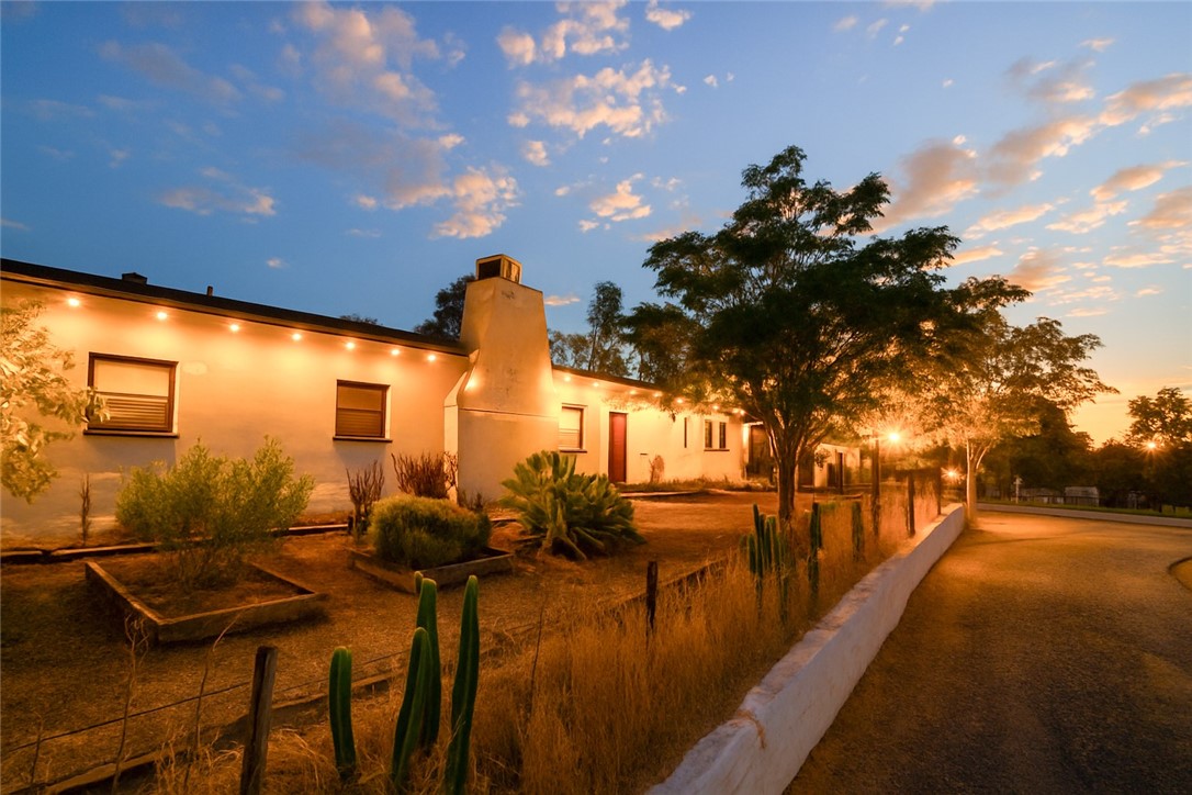 Step into a one-of-a-kind property that beautifully blends history, character, and opportunity. Thought to reflect the influence of celebrated mid-century architect Cliff May—known for his iconic California ranch homes—this adobe residence showcases the timeless craftsmanship and design that made his style so enduring.
Set on a generous 2.16-acre lot, this historic Ranch Adobe offers both charm and endless potential. The home is anchored by a remarkable quartz foundation, believed to have been sourced from the nearby Quartz Mine, lending a natural and distinctive touch to its structure. Surrounding the residence, you’ll find an abundance of mature fruit trees—plum, guava, orange, peach, and olive—as well as desert-inspired landscaping with cactus and garden beds that create a serene outdoor retreat.
The property is well-equipped for a variety of lifestyles and interests. A 9-stall barn , a detached two-car garage features an additional apartment with exciting potential for transformation. There’s plenty of room for RVs and recreational toys, with hookups already in place.
Inside the main home, warm natural light filters through large windows, highlighting the wood-burning fireplace and creating inviting living spaces. A separate entrance offers flexibility for an in-law suite, guest quarters, or even a private office.
Rich with history and surrounded by nature, this property is more than just a home—it’s an opportunity to create your own vision. Whether you’re seeking a peaceful retreat, a multi-use estate, or a unique investment, this rare offering is ready to welcome its next chapter.