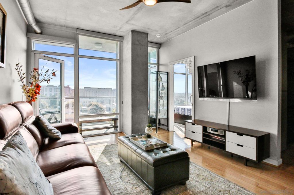 Urban Chic and stylish 1 bedroom + office/den or 2nd bedroom, featuring exposed concrete walls & 10' ceilings, floor to ceiling windows in living area & master bedroom- balcony off both rooms.This unit includes bamboo hardwood flooring, granite countertops, like-new stainless steel appliances, custom paint, and wood ceiling fans in living room and bedroom, an open floor plan w. bar seating. In-unit laundry and central ac/heat. Fully equipped fitness studio,Stunning 20th Flr Rooftop w. Hot-tub. ****Professionally Staged and Easy to Show!**** Sunny, Impeccable Condo in the fashionable East Village! Easy access to the Trolley, Trendy Restaurants/Bars and Gyms! Enjoy the epitome of Downtown Living at a fraction of the prices of other buildings downtown! Equipment: Dryer,Fire Sprinklers, Washer Other Fees: 0 Sewer: Sewer Connected Topography: LL