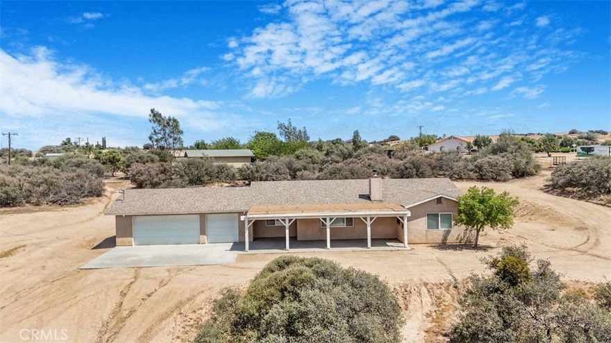 Charming single-family home located in the highly desirable Oak Hills community. This beautifully residence offers 3 spacious bedrooms and 2 full bathrooms across 1,748 square feet of living space. Built in 2005 and set on a generous 2.25-acre lot, this home provides the perfect blend of comfort, privacy, and scenic beauty.

Step inside to a large living room featuring a cozy wood-burning stove and windows that frame stunning views of the surrounding landscape. The open-concept layout seamlessly connects the living area to the kitchen and dining spaces, making entertaining both easy and enjoyable. The kitchen is well-appointed with tile countertops and backsplash, recessed lighting, a large double sink, pantry, microwave, and windows that invite natural light and picturesque views.

Both bathrooms are thoughtfully designed with double sinks, tile counters, oversized mirrors, and tub/shower combinations. Throughout the home, you'll find custom ceilings, decorative interior doors, dual-pane windows, and stylish tile flooring that add character and charm. A dedicated laundry room with cabinetry and counter space is conveniently located next to the garage for added functionality.

Outside, enjoy a spacious covered front patio—perfect for relaxing and taking in the peaceful surroundings. The fully fenced and gated property offers RV access and is adorned with mature trees and bushes, creating a serene and private atmosphere. Located in a quiet area, this home offers the tranquility of rural living with the convenience of nearby amenities.

Don’t miss this rare opportunity to own a well-appointed home on over two acres of land in Oak Hills. Whether you're looking for space to grow, entertain, or simply unwind, this property delivers it all.