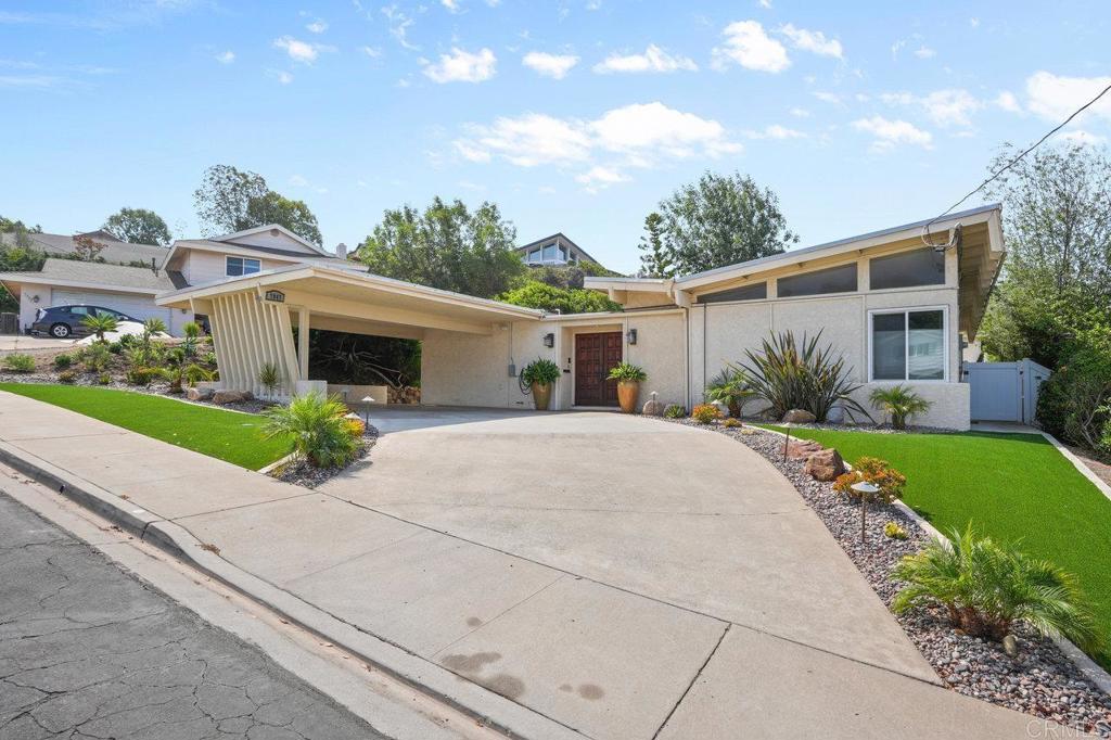 Seller will entertain offers from $1,050,000 to $1,150,000. This mid-century gem is brimming with character, natural light, and an entertainer’s spirit. Designed with ample windows, custom architectural details, and a one-of-a-kind mid-century modern fireplace in the kitchen and breakfast nook, this home blends style with function. Step through the double-door entry to find open, versatile spaces — from the oversized family room with sliding doors to the exterior, a formal living room and dining room and additional square footage ideal for an office area. The oversized kitchen offers bench seating with storage, KitchenAid appliances, and pull-out ShelfGenie pantry/cabinet shelves. Tile floors in high-traffic areas, carpet in formal rooms, and built-ins throughout add both comfort and convenience. The primary suite features a walk-in closet, and the hall bath has been beautifully remodeled. Set in the highly regarded La Mesa-Spring Valley School District, close to La Mesa Arts Academy (LMAAC) and Helix High School, this home is minutes from Downtown La Mesa’s summer car shows, Friday Farmer’s Market, charming shops, and acclaimed restaurants. Relax in your sparkling pool, or host friends and family with ease — this home was made for gatherings. Easy freeway access to the 8, 125 and 94 freeways. Paid solar, pool, and ample square footage make this La Mesa residence a rare find.