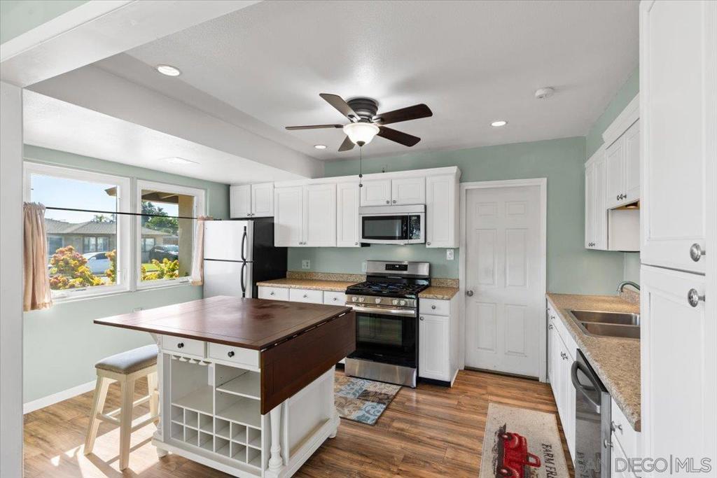 This exceptionally maintained 2bed, 1bath in the heart of College Grove/Rolando Park offers 1,155 sq ft of bright, clean, and thoughtfully updated living space. You’ll instantly notice the abundance of natural light, large space and move-in ready updates that include a newer roof and upgraded plumbing. Outside is truly a private backyard oasis. Sitting .34 aces, fully fenced, canyon lot, with an expansive terrace and incredible panoramic views. Whether you're relaxing in the quiet beauty of nature, entertaining guests, or planning for a future ADU, this outdoor space offers endless possibilities. The detached bonus room adds even more flexibility — perfect for a home office, guest suite, creative studio, or extra entertainment space. In addition, enjoy plenty of additional storage and a convenient oversized 1-car garage. Tucked away in a peaceful neighborhood yet just minutes from shopping, SDSU, and major freeways, this home truly offers the best of both worlds: privacy, space, and location. If you’ve been searching for a move-in ready home with charm, views, and room to grow — this is it.