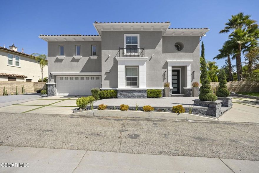 Modern Mediterranean curb appeal leads the way to this beautifully updated residence tucked away on a quiet cul-de-sac. The facade pairs smooth light gray stucco with crisp white trim, stacked stone planters, a sleek glass panel front door, and a driveway inset with turf, allowing ample parking. Inside, a grand foyer showcases a sweeping staircase with black iron balusters. Fresh interior paint, natural wood flooring on the main level, updated hardware, and recessed LED lighting give every space a refined feel. A downstairs bedroom with an en-suite bathroom is perfect for guests or a home office. The living room centers on a corner fireplace topped by a TV niche, while the adjacent great room is bright and comfortable with picture windows framing the backyard. The dining room features a modern rectangular chandelier and opens to the pergola, which is perfect for indoor/outdoor entertaining. The chef's kitchen is finished in timeless white cabinetry with Cristallo quartzite counters with an island, subway-style backsplash, pendant lighting, and premium stainless steel appliances, including a built-in refrigerator and double ovens. Upstairs, the serene primary suite is generously sized with plantation shutters and a designer ceiling fan. The doors and windows capture hillside vistas and natural light and, is the perfect place to sit and enjoy a drink or read a book. Upstairs offers three additional guest rooms and a loft/movie viewing room. Out back, a resort-size yard just under an acre delivers the California lifestyle: an expansive lawn, a sparkling pool with sun deck, a circular conversation/firepit area, and a shaded pavilion/pergola all set against open space for rare privacy and sunset views. The fenced yard offers an expansive grassy area perfect for pets. Extensive solar (owned free and clear) pairs with a Tesla Powerwall for energy efficiency and backup. Additional upgrades include a custom metal front door and new windows in the media room.