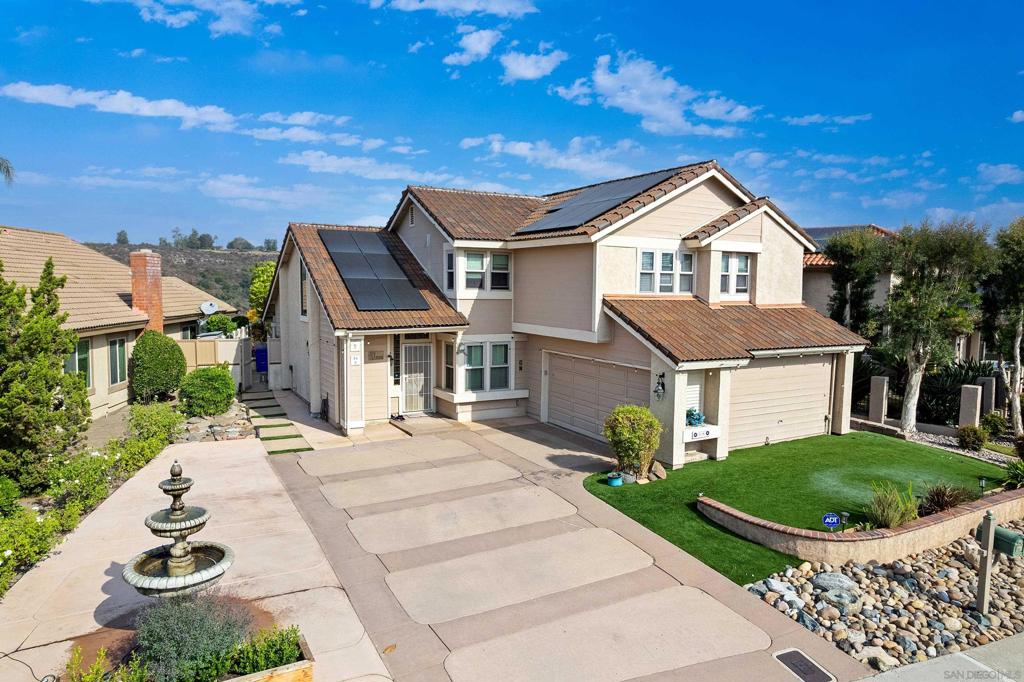 Remodeled Tierrasanta home with canyon views! Modern kitchen with quartz counters, shaker cabinets, center island & stainless appliances opens to family room with yard access. Living room features vaulted ceilings, skylights & dual-sided fireplace. Primary bedroom offers balcony, ensuite bathroom with soaking tub and separate shower. Backyard includes trellis patio, grassy area & firepit. Extras: solar, EV charger, LVP flooring, central A/C, laundry room, large driveway & low-maintenance front yard. This beautifully updated Villa Granada home blends modern comfort with timeless character. The remodeled kitchen showcases quartz counters, shaker cabinetry, marble backsplash, and recessed lighting, seamlessly connecting to the family room with sliding doors to the yard. A dramatic living room offers vaulted ceilings, skylights, stained-glass window, and a dual-sided fireplace shared with the family room. The spacious primary suite includes mirrored closets, vaulted ceilings, a private balcony overlooking the canyon, and a spa-like bath with dual vanities, soaking tub, and walk-in shower. Three additional bedrooms plus an upgraded hall bath provide ample space for family or guests. Added conveniences include an indoor laundry room with washer/dryer, attic storage with pull-down access, and porcelain tile flooring in the entry and dining areas. Outdoors, enjoy a trellis-covered patio, firepit, grassy yard, synthetic turf front, and privacy with canyon views. Extras: Tesla charger, financed solar, central A/C, and a wide driveway with plenty of parking. Convenient central Tierrasanta location near parks, trails, shops, and schools.