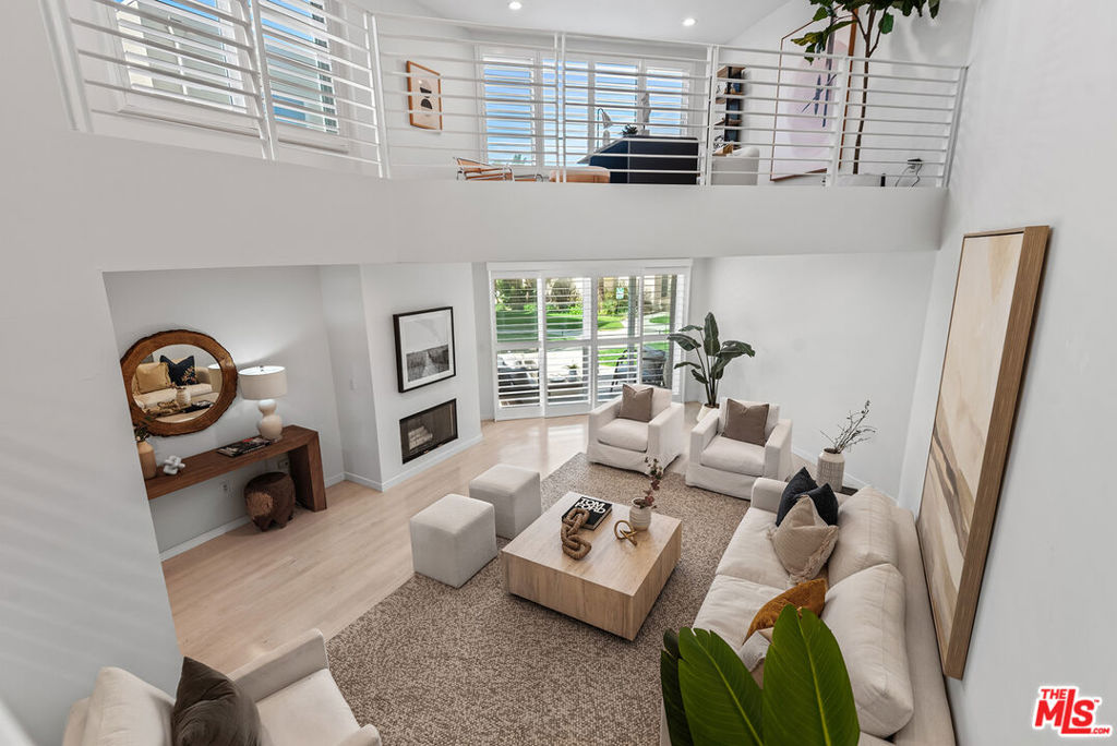 Just steps from the sand, this stunning multi-level, 2-bedroom, 2.5-bathroom + loft corner unit with only one shared wall offers resort-like coastal living at its finest. Located in the desirable Breakers community, this home features high ceilings, an open floor plan with beautiful wood floors, recessed lighting, and ocean views. The expansive living room opens to a private patio, creating a seamless indoor/outdoor flow perfect for relaxation and entertaining. The chef's kitchen boasts stainless steel appliances, granite countertops, and a breakfast bar, making this home ideal for gatherings. Upstairs, from the living room and kitchen, you will be greeted by the versatile loft, perfect for a home office, den, or possible 3rd bedroom. The top floor showcases the spacious primary bedroom with spectacular ocean views, offering a serene and tranquil escape. It includes an en-suite, spa-like bathroom with a dual vanity and separate shower and tub. Additionally, the unit offers extra storage, side-by-side parking spaces, central air and heat, and in-unit laundry. The coveted Breakers complex provides outstanding amenities, including a pool, spa, gym, rec room, basketball court, gardens, and guest parking. This is the beachside retreat you've been searching for!