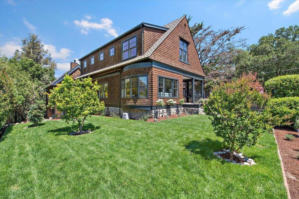 Celebrating one of America's most original and beautiful architectural idioms - this 19th century Shingle Style Home was extensively restored and expanded in 2000 to create an heirloom home of impeccable design and utility ideal for today's modern family living. Located on an iconic street steps from downtown this home offers the best in terms of location, history and modern floorplan. The main house marries formal and informal living with an elegant living room, music room, office and formal dining room featuring stunning bow windows, intricate hardwood floor inlays and custom lighting. A large kitchen, family room and breakfast room make up the informal living space and benefit from stunning open beam paneled ceilings. The upper floor houses a spacious primary suite with private deck as well as a "junior wing" featuring 2 bedrooms, bathroom and den. The lower floor has a large 2 car garage, bicycle room, rumpus room, 2 bedrooms and 2 bathrooms as well as a covered patio/summer room. The original carriage house was revitalized in 2000 and now features a 2 car garage/workshop with a 440SF ADU below with full kitchen and bath (Total 4490 SF) All of this is located on a beautiful ~20,000 SF graded and landscaped lot leading down to a seasonal creek with plenty of space for a pool.