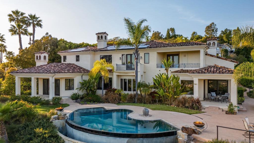 This stunning 7-bedroom, 7.5-bathroom estate blends comfort, charm, and opulence. Nestled on beautifully landscaped grounds, it features an infinity pool with breathtaking mountain views, peek ocean vistas, and a beautiful backyard outlook. The expansive kitchen boasts an island with scenic views of the pool and yard, perfect for gatherings. The inviting living room, with a cozy fireplace and Smart TVs throughout, offers a relaxing atmosphere. Step outside to an outdoor space ideal for lounging by the pool, dining al fresco, or grilling on the BBQ. This grand retreat includes a 3-car garage with additional parking for up to 6 vehicles. With central heat and AC, the home ensures year-round comfort in a tranquil yet refined setting. Please note, pets are not allowed. A $150/day pool heating fee applies. A 30-night minimum stay is required. Please note, this home is offered furnished or unfurnished. Please contact management for more information. Sleeping Accommodations (Max Occupancy 14): Bedroom 1 - King bed Bedroom 2 - King bed Bedroom 3 - King bed Bedroom 4 - King bed Bedroom 5 - King bed Bedroom 6 - Queen bed Bedroom 7 - Queen bed The estate features 7 full bathrooms and 1 half bathroom.