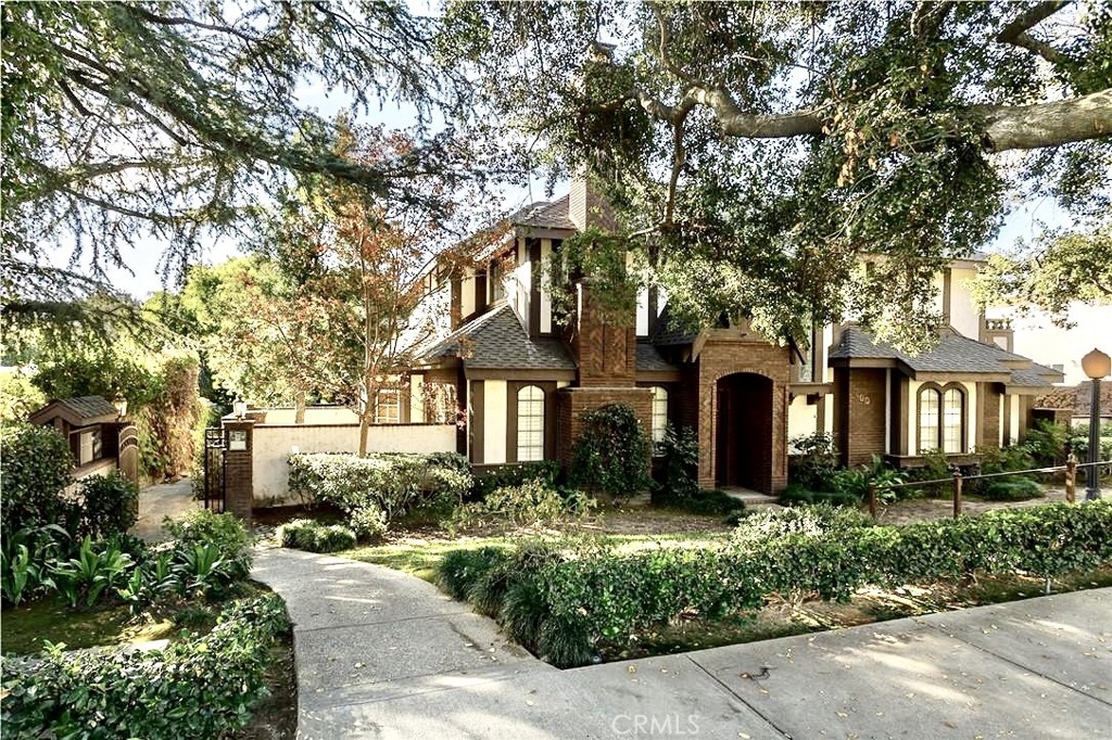 This stunning Tudor-style, 2-story townhouse is nestled on a charming, tree-lined street just steps from the quaint downtown area. The home boasts a blend of luxurious hardwood, limestone, sandstone, and travertine flooring throughout, paired with elegant crown and chair rail molding, beadboard paneling, and recessed lighting. The custom-designed fireplace mantle and wood shutters add a touch of timeless character. The spacious kitchen features brand-new quartz countertops, a sleek stainless steel sink, a dishwasher, and a large walk-in pantry, perfect for both everyday cooking and entertaining. The primary bedroom is a true retreat with a custom-organized walk-in closet, a private balcony, and an ensuite bathroom complete with a spa tub and dual-sink vanity. Storage is abundant in this home, with a large linen closet in the upstairs hallway, a pull-down attic for additional space, and an attached two-car garage equipped with EV charging capabilities. The flowing floor plan and generously sized rooms create an inviting atmosphere for comfortable living. Enjoy the best of both worlds—peaceful, nature-inspired surroundings with all the convenience of city living just steps away.