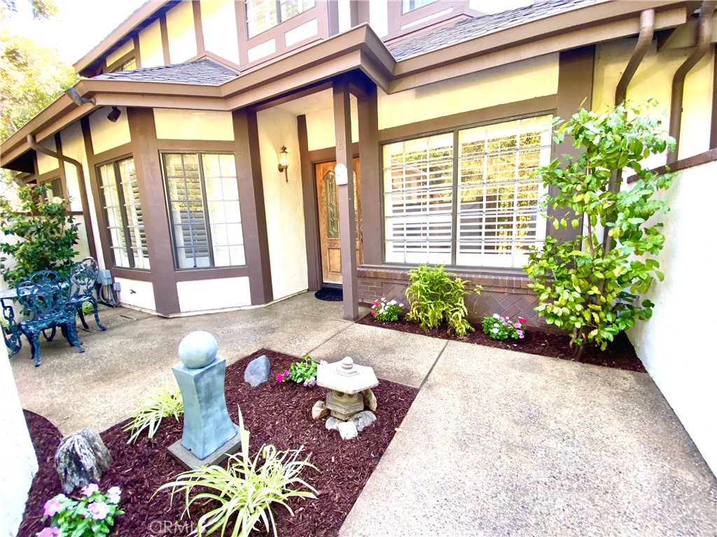 This stunning Tudor-style, 2-story townhouse is nestled on a charming, tree-lined street just steps from the quaint downtown area. The home boasts a blend of luxurious hardwood, limestone, sandstone, and travertine flooring throughout, paired with elegant crown and chair rail molding, beadboard paneling, and recessed lighting. The custom-designed fireplace mantle and wood shutters add a touch of timeless character. The spacious kitchen features brand-new quartz countertops, a sleek stainless steel sink, a dishwasher, and a large walk-in pantry, perfect for both everyday cooking and entertaining. The primary bedroom is a true retreat with a custom-organized walk-in closet, a private balcony, and an ensuite bathroom complete with a spa tub and dual-sink vanity. Storage is abundant in this home, with a large linen closet in the upstairs hallway, a pull-down attic for additional space, and an attached two-car garage equipped with EV charging capabilities. The flowing floor plan and generously sized rooms create an inviting atmosphere for comfortable living. Enjoy the best of both worlds—peaceful, nature-inspired surroundings with all the convenience of city living just steps away.