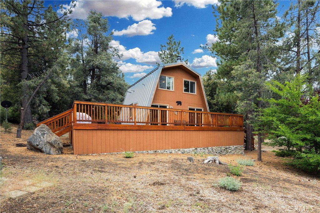 Set on a large R-3 zoned lot, just under half an acre, this property opens the door for future development opportunities while offering plenty of space to enjoy right now. Whether you're thinking of adding a guest house, garage, or expanding the existing footprint, the potential is there.
The home itself is a 2-bedroom, 2-bath retreat that blends rustic warmth with modern comfort. With its classic gambrel design, metal roof, and expansive wraparound deck, it’s well suited for full-time living or weekend getaways.
Inside, the main level features wood-beamed ceilings, original parquet floors, and an open living area anchored by a pellet stove—ideal for cozy nights in. The kitchen is functional and mountain-ready, with ample storage and thoughtful design touches.
Also on the main floor is a bedroom with a cedar-lined walk-in closet and a full bathroom with a tub/shower combo. Upstairs, you’ll find high vaulted ceilings, a flexible entertainment space, another open-style bedroom, and a bathroom with a walk-in shower.
Natural light pours through large windows and sliding glass doors, offering peaceful views of the surrounding hills.
Located on a street that receives early snow removal and just steps from local shops, restaurants, and amenities, this home strikes a rare balance between privacy and convenience.
Membership in the Pine Mountain Club Property Owners Association grants access to a range of amenities including an Olympic-style swimming pool and spa, tennis and pickleball courts, an equestrian center, a scenic nine-hole golf course, and more. Essential community services are also provided, including round-the-clock patrol, waste and recycling management, street maintenance, and snow clearance. The presence of Kern County Fire Station 58, complete with paramedics and a helipad, guarantees swift emergency responses, offering residents a sense of security.