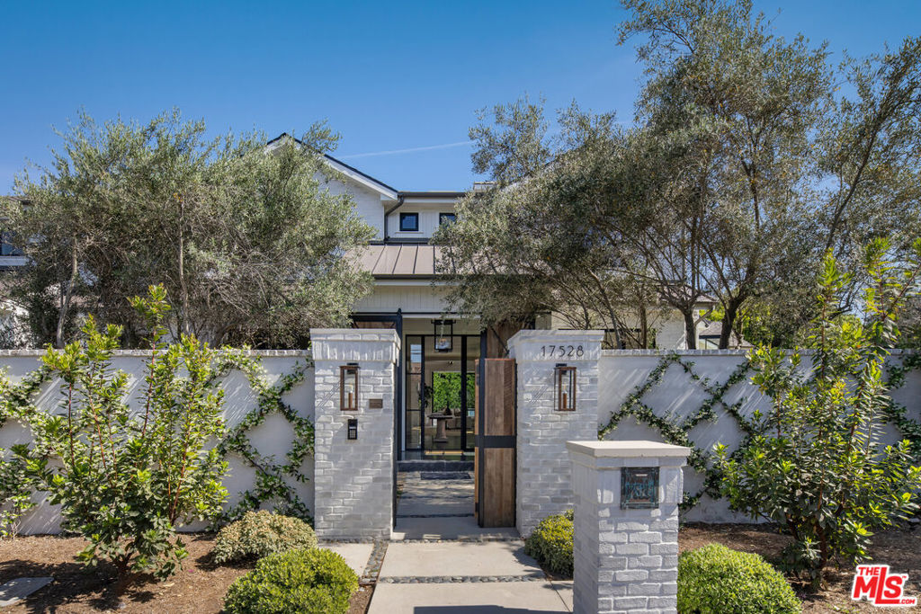 Set on a sun-drenched corner of sprawling grounds, this brand new, impeccably designed, contemporary ranch estate illustrates a masterclass in California-Countryside living. Reclaimed wood barn doors and vintage olive trees reveal the Farmstead; a rustic and refined development by the visionaries at Red Door Homes. Enter the foyer to a functional, thoughtfully designed floor plan that feels expansive yet grounded. Truss beams sourced from an 1800's barn frame the vaulted family room and curated library that anchor the living space. The chef's kitchen, bespoke and sophisticated, complete with top-of-the-line appliances, a prep kitchen, and a large walk-in pantry, open seamlessly to multiple dining areas, formal and family style, including a shaded terrace with a grill and outdoor fireplace designed for slow mornings and late summer dinners. Each space has been perfectly articulated for indoor-outdoor entertaining, with sliding glass doors and windows opening to the grounds and a shimmering pool reflecting the surrounding greenery. Just beyond, the guest house offers a private retreat for visitors, complete with its own kitchen and garden views, while a discreetly placed sports court blends into the landscape. An office, guest room, and mudroom complete the first level with a curated palette of oak, linen, and stone throughout. Upstairs, warm organic textures are continued in three generously sized guest rooms, all with ensuite bathrooms, and a primary suite with its own lounge and fireplace provides all the luxury amenities. Every element of this property has been chosen with intention, creating a truly special space that feels timeless. The perfect take on the classic ranch with elegance built into every corner.