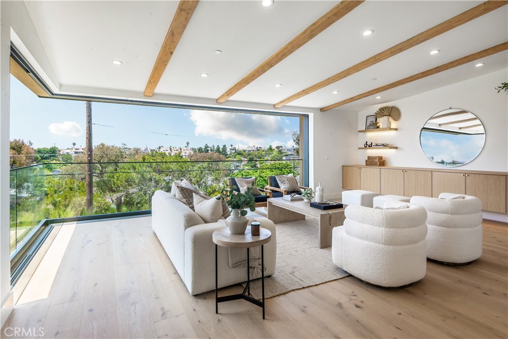 This brand-new, custom-built, modern coastal retreat blends refined design with exceptional craftsmanship. Spanning nearly 4,000 square feet, this thoughtfully curated home is just a short stroll from the greenbelt, Valley Park, and the vibrant energy of Pier Avenue. Step into a light-filled sanctuary where expansive open-concept living meets modern sophistication. A stunning 28-foot wall-to-wall sliding glass door seamlessly connects the interior to the outdoors, framing serene views of the greenbelt and Hermosa Valley. The chef’s kitchen is a standout centerpiece, featuring a 48-inch Wolf gas range with dual ovens, Sub-Zero side-by-side refrigerator/freezer, and a beautiful 10-foot marble island. Retreat to the spa-inspired primary suite, where a freestanding soaking tub and oversized rain shower create a true sanctuary. A 12-foot slider and french doors open to a private outdoor escape, blending indoor comfort with serene exterior living. Each bathroom is thoughtfully finished with premium fixtures and designer details for a cohesive, elevated experience. A spacious deck off the top level is perfect for grilling and chilling, while the rear patio offers a cozy outdoor lounge and lush landscaping—ideal for entertaining or unwinding in style. Additional highlights include an EV-ready garage, solar panels and carefully selected finishes that balance functionality with luxury. With thoughtful design throughout and premium appliances in every corner, this home is a true coastal masterpiece—crafted for comfort, style, and effortless California living. WHEN YOU BUY HERE, YOU’RE BUYING A LIFESTYLE.