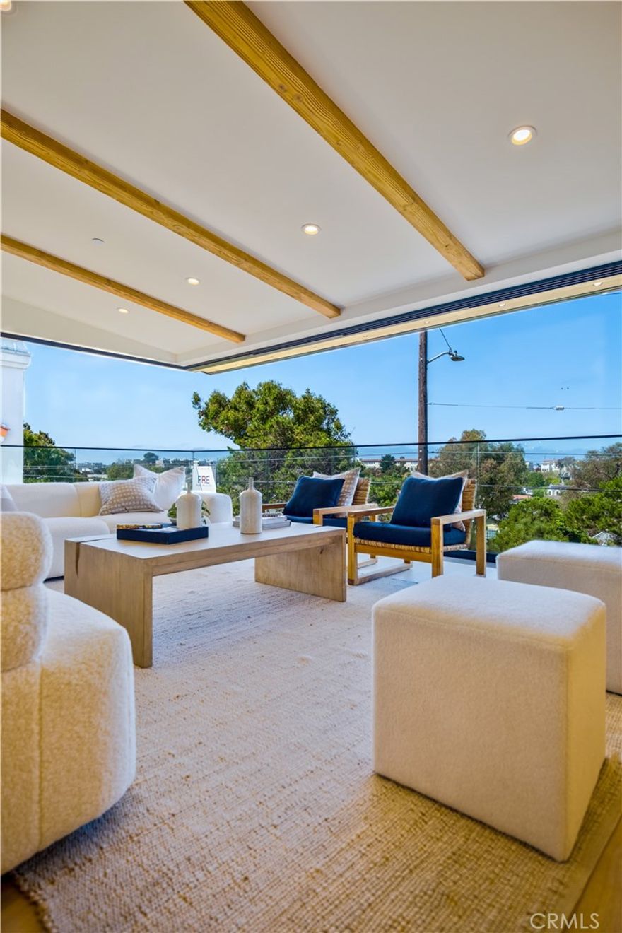 Brought to you by Pacific Design Build, whose team has been featured in Architectural Digest, CA Home & Design, Domain Home and Open House on NBC. This brand-new, custom-built, modern coastal retreat blends refined design with exceptional craftsmanship. Spanning nearly 4,000 square feet, this thoughtfully curated home is just a short stroll from the greenbelt, Valley Park, and the vibrant energy of Pier Avenue. Step into a light-filled sanctuary where expansive open-concept living meets modern sophistication. A stunning 28-foot wall-to-wall sliding glass door seamlessly connects the interior to the outdoors, framing serene views of the greenbelt and Hermosa Valley. The chef’s kitchen is a standout centerpiece, featuring a 48-inch Wolf gas range with dual ovens, Sub-Zero side-by-side refrigerator/freezer, and a beautiful 10-foot marble island. Retreat to the spa-inspired primary suite, where a freestanding soaking tub and oversized rain shower create a true sanctuary. A 12-foot slider and french doors open to a private outdoor escape, blending indoor comfort with serene exterior living. Each bathroom is thoughtfully finished with premium fixtures and designer details for a cohesive, elevated experience. A spacious deck off the top level is perfect for grilling and chilling, while the rear patio offers a cozy outdoor lounge and lush landscaping—ideal for entertaining or unwinding in style. Additional highlights include an EV-ready garage, solar panels and carefully selected finishes that balance functionality with luxury. With thoughtful design throughout and premium appliances in every corner, this home is a true coastal masterpiece—crafted for comfort, style, and effortless California living. WHEN YOU BUY HERE, YOU’RE BUYING A LIFESTYLE.