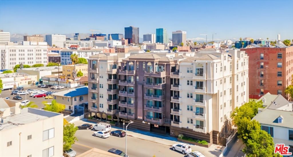 Prime Location in the Heart of Koreatown! Welcome to this upgraded 3-bedroom, 2-bathroom home in a gated building on the 4th floor, offering city lights views and a spacious balcony. Step inside to a formal entry that opens into a bright, airy living room with hardwood floors in the common areas and cozy carpet in the bedrooms. The modern kitchen features quartz countertops, a breakfast bar, stylish backsplash, sleek cabinets, and matching stainless steel appliances, plus the convenience of an in-unit washer and dryer. The primary suite includes a walk-in closet, a large window overlooking Wilshire Blvd, and a bathroom with quartz countertops, tiled flooring, and a tub/shower combo.Residents enjoy access to a gym and recreation room within the beautifully designed building. All this just steps away from renowned restaurants, markets, shops, schools, pharmacies, and the Wilshire/Normandie Metro station making this home the perfect blend of comfort and convenience.