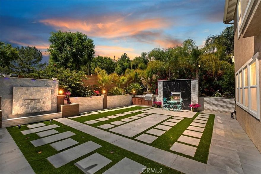 Absolutely Stunning 3,333 Sq Ft Estate in The Retreat – Corona’s Premier Gated Community! Nestled on a peaceful cul-de-sac within The Retreat, this exceptional residence showcases timeless architecture, no-expense-spared owner has spent more than $275,000 on recent high end finishes, and the home has a thoughtfully designed floor plan perfect for modern living. This exquisite home offers 4 bedrooms, a spacious loft/game room, and a chef’s dream island kitchen—complete with quartz counters, double ovens, white cabinetry with glass inserts, designer pendant lights, a built-in desk, a walk-in pantry, and under-cabinet accent lighting. Step through the elegant double-door entry into a grand living space featuring a step-down living room, formal dining room, large family room with a gorgeous porcelain tile fireplace, and a large laundry room with sink. Upstairs, the master suite is a true retreat, boasting a coffered ceiling, dual walk-in closets, and a spa-like bath adorned with marble and porcelain finishes on the vanities, tub, and shower—designed for pure indulgence. The Zen-inspired backyard is an entertainer’s dream, complete with a beautiful marble fountain, porcelain fireplace, all marble walls, brand-new built-in BBQ, full-size patio cover, and LED accent lighting that sets the mood throughout. Additional luxury features include:Mosaic-tiled front porch with fountain, Plantation shutters, crown molding, Egyptian crystal chandeliers, elegant drapes, 10,454 Sq/Ft lot with perimeter block walls, 3-car garage,and Breathtaking mountain views throughout the community. This is a once-in-a-lifetime opportunity to own a truly exceptional property in a sought-after location!