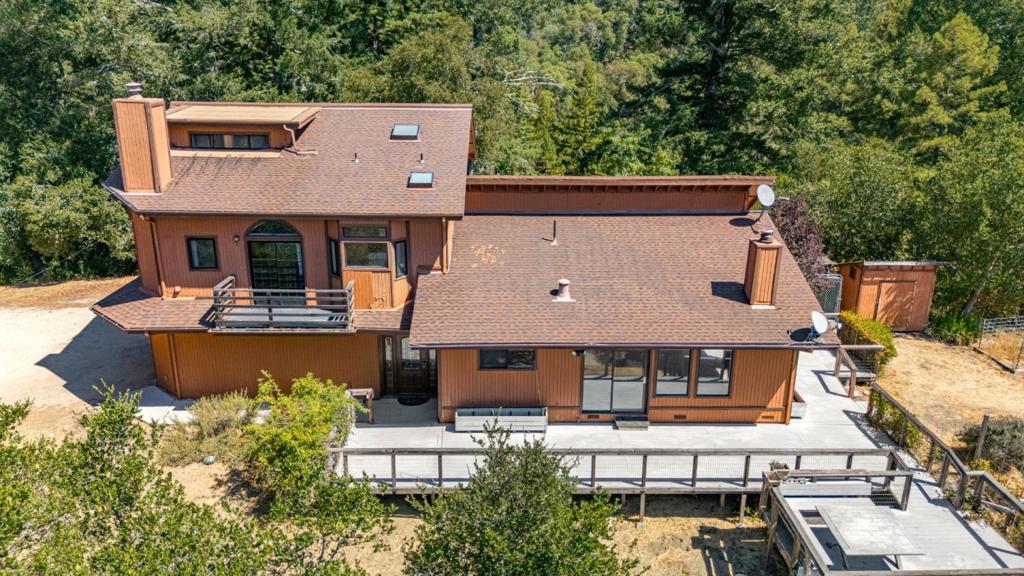 Mountain living at its finest. This custom built 4 BR 3 bath home is located just 10 minutes from Boulder Creek and 25 minutes to Los Gatos on 8 sun drenched acres. Stunning mountain views from every window and deck. Two private primary suites, one with a fireplace and private deck with views of the sunrise over the mountain ridge. Family room/dining room combo off the kitchen features a vaulted wood ceiling and raised stone fireplace. This home is all electric, the perfect home to add solar. A three car garage with one oversized bay for a RV or boat. Outside you will find a wrap around deck and raised beds for the gardeners. Picture your chickens free range roaming around their coop. This home has a wonderful neighborhood feel but distance between neighbors for privacy.