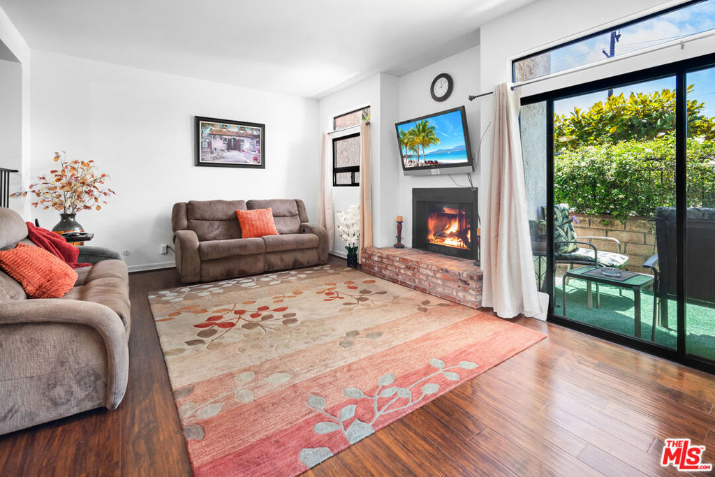 Welcome to this beautifully maintained and light-filled 3-bedroom, 2.5-bathroom end-unit townhome located in the highly desirable and gated Magnolia Tree Villas community in Valley Village. Offering over 1,645 sq. ft. of well-designed living space, this rare corner unit lives like a private home with only one shared wall, lush garden surroundings, and an abundance of natural light throughout. The main level features a spacious kitchen with ample cabinetry and generous counter space, flowing seamlessly into the formal dining area. Just beyond, the step-down living room boasts a cozy fireplace and opens directly to a private patio perfect for morning coffee, alfresco dining, or relaxing with friends. Upstairs, the expansive primary suite includes vaulted ceilings, a large walk-in closet, and a private en-suite bathroom. Two additional bedrooms, each bright and airy, share a full hallway bath. A full-size laundry area with side-by-side washer and dryer is conveniently located near all three bedrooms. Since the unit faces Magnolia Boulevard, one of its key advantages is that your windows do not face another building offering added privacy and open views. Even better, the home is equipped with sound-reducing windows that help maintain a peaceful, quieter indoor environment despite the central location. This townhome also includes two side-by-side subterranean parking spaces, along with 10 additional non-gated guest spots, plenty of room for visitors. The well-managed HOA includes earthquake insurance, water, gas, sewer, garbage, and common area maintenance, offering peace of mind and excellent value. Magnolia Tree Villas offers resort-style amenities including beautifully landscaped grounds, secure entryways, an elevator, a sparkling pool and spa, a fully equipped fitness center, and a relaxing outdoor seating and party area. The community is ideally located within the highly sought-after Colfax Charter School district, near Metro lines, major studios, Ventura Boulevard, local parks, and the vibrant NoHo Arts District with easy access to freeways and daily conveniences. This is a rare opportunity to own a stylish, townhome in one of Valley Village's most sought-after communities. Don't miss your chance to enjoy the perfect blend of comfort, location, and lifestyle.