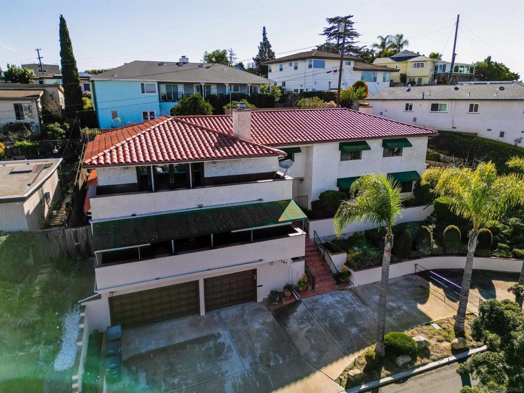 Wow! Views! and so much more to fall in love with! How about a multigeneration family home or an investor's dream? 5 bedrooms (tax record says 4), & four full bathrooms. Entry level is 3-car garage, (built-in elevator shaft-no elevator). 2nd level is first floor of home - giant entertainment room, 1 large bedroom, living room, formal dining, spacious kitchen, kitchenette, family room w/fireplace & 2 full bathrooms. 3rd level has four bedrooms & 2 full baths. Primary has fireplace-large designer bathroom w/mirrored closets and full walk-in closet. Other end of hall has 3 bedrooms, 12x10 laundry room-(convert to a kitchen?) Close to La Mesa Village, freeways and schools.