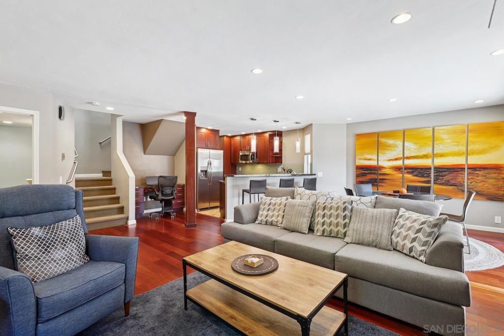 Welcome to Woodlands West in La Jolla Village—an exceptional two-story townhome ideally located west of the 5 freeway, just minutes from UCSD, La Jolla Shores, top-rated schools, and premier shopping and dining. This beautifully updated residence features an attached two-car garage and is nestled within a parklike community offering resort-style amenities including a pool, tennis courts, and clubhouse. Step inside to find an open floor plan with gorgeous wood flooring, recessed lighting, and a cozy fireplace in the living room. The stunning kitchen boasts rich cherry-hued cabinetry, granite countertops, stainless steel appliances, and a breakfast counter that flows seamlessly into the living and dining areas. A convenient office nook adds versatility to the main living space. The home also features a large, private patio—perfect for relaxing or entertaining. Upstairs, you'll find all bedrooms, including a spacious primary retreat with vaulted ceilings, a private balcony sitting area, an en-suite bath, and ample closet space. A junior suite with its own en-suite bath provides added comfort and privacy. Don't miss this opportunity to live in one of La Jolla's most desirable communities, offering both comfort and convenience in a serene, coastal setting.