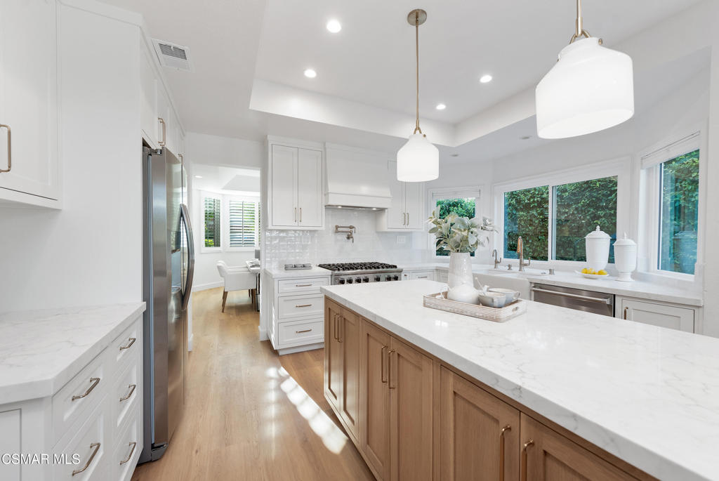 Reimagined with style and functionality, this custom-renovated 4-bedroom, 3-bath home offers timeless design and move-in-ready comfort. Completed with permits and never lived in, the interior features a professionally designed layout anchored by a stunning chef's kitchen with custom cabinetry, premium finishes, and top-of-the-line Viking stove and dishwasher. The kitchen flows seamlessly into the open living and dining areas, creating an ideal space for everyday living and entertaining. All bathrooms have been tastefully updated, and new flooring runs throughout the home, enhancing its fresh, contemporary feel. A desirable downstairs bedroom with a full bath offers flexible use for guests, a home office, or multi-generational living. Outside, enjoy a private backyard retreat with a sparkling pool, scenic views, and a grassy play area--perfect for entertaining or relaxing in the sun. The finished garage adds extra space for a home gym, creative studio, or storage. A rare opportunity to own a turnkey, design-forward home with permitted upgrades in a great location.