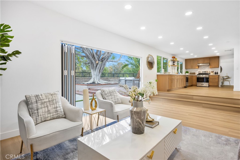 Welcome to 27662 ESLA, a BEAUTIFULLY REMODELED HOME in the prestigious MADRID DEL LAGO community in the heart of MISSION VIEJO—an area known for its charm, serenity, and high demand. From the moment you enter, you’re welcomed by SOARING CEILINGS, ABUNDANT NATURAL LIGHT, and a thoughtfully designed OPEN LAYOUT that feels both spacious and inviting. The entire home has been tastefully upgraded, featuring BRAND-NEW WINDOWS THROUGHOUT, ELEGANT NEW FLOORING, and a CHEF’S KITCHEN complete with WARM OAK CABINETRY, SLEEK WHITE GRANITE COUNTERTOPS, and PREMIUM STAINLESS STEEL APPLIANCES. A COZY INDOOR FIREPLACE anchors the living space, and a GIANT FOLDING DOOR opens wide to the backyard, creating the ultimate INDOOR-OUTDOOR LIFESTYLE. Whether entertaining or enjoying a quiet evening, the BEAUTIFULLY LANDSCAPED BACKYARD offers PRIVACY, SERENITY, AND SPACE—plus a LARGE SIDE YARD WITH POTENTIAL RV PARKING. Upstairs, the generous PRIMARY SUITE features PEACEFUL VIEWS, a SPACIOUS LAYOUT, and AMPLE CLOSET SPACE. All bathrooms have been FULLY RENOVATED WITH HIGH-END FINISHES AND THOUGHTFUL DESIGN. Additional highlights include a GARAGE WITH AN EPOXY-COATED FLOOR, adding both durability and a clean, finished look to your storage or workspace.vPerfectly situated on A QUIET, WELL-KEPT STREET, this home truly stands out as one of the most desirable properties in the Madrid Del Lago community. You also have ACCESS TO LAKE MISSION VIEJO AMENITIES, including access to the lake, picnic areas, beach, fireworks, concerts, and more.