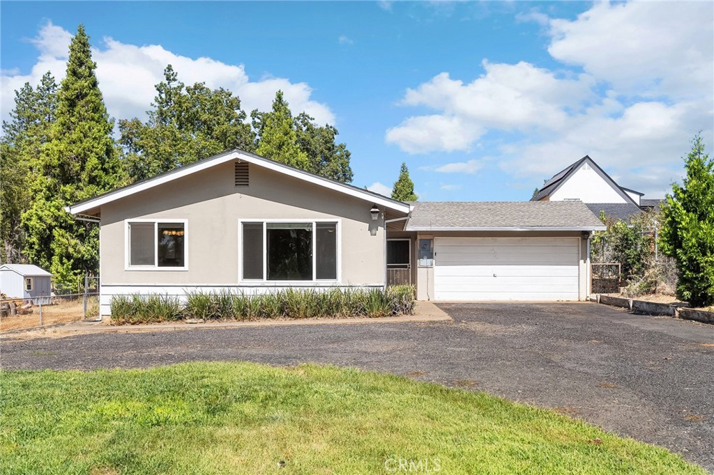 Welcome to 1491 Nunneley Rd, a darling 2-bedroom, 2-bathroom home spanning 1,058 sq. ft. on over a quarter-acre lot. Lovingly updated and move-in ready, this home is filled with natural light and ready for its next owner to make new memories. Step inside to find a bright and spacious living room with laminate flooring and large windows that flood the space with sunshine, creating a warm and inviting atmosphere. The living area flows into a generous dining room, perfect for hosting family dinners or casual get-togethers. The kitchen is just as charming, with a gas range, large pantry, and a convenient door to the outside, making summer BBQs a breeze. The second bedroom is filled with natural light, offering laminate floors, a ceiling fan, and a large window overlooking the property. The hall bath features an updated vanity and plenty of space, while the primary suite offers a large closet and an ensuite bathroom with a step-in shower. Outside, the fully fenced yard is a blank canvas for your imagination, ready for a lush garden, play area, or entertaining space. An oversized concrete patio provides the perfect spot for outdoor dining or weekend BBQs, with plenty of room left over for pets, gardening, or adding a future fire pit. There’s even RV/boat parking with a wide gate and a large storage shed. Practical upgrades make this home even more appealing, including a Generac generator connected to the home for instant power when needed, laundry hookups in the attached two-car garage, and ample parking in the driveway. With its sun-filled spaces, modern updates, and oversized lot, 1491 Nunneley Rd offers the perfect combination of comfort, security, and potential, ready for you to bring your vision to life.