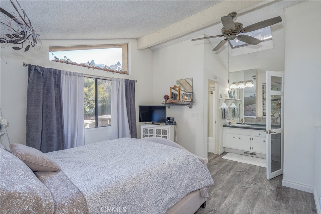 **FANTASTIC END UNIT (UNIT #24)** Welcome to your exquisite new home nestled in the stunning foothills of Orange, located in the highly sought-after Orange Lakes Community. This neighborhood offers charming water features, bridges, and lush, mature landscaping that creates a tranquil atmosphere. As you step inside, you are greeted by natural light that creates a cheerful, bright, and cozy atmosphere. The Mid-Century cone fireplace stands as a focal point in the main living area, serving not only as a source of warmth but also as a stylish conversation piece. NEW WOOD LAMINATE FLOORS and BASEBOARDS enhance the home, while the soaring ceilings add an element of sophistication. Just off the living room, a private patio awaits, providing a perfect oasis for relaxation after a long day or an ideal space for hosting friends and family during gatherings. The kitchen is a bright space featuring NEW REFINISHED COUNTER TOPS and ample cabinets that offer plenty of storage. A convenient serve-over bar invites casual dining experiences. Upstairs, you will discover the primary bedroom sanctuary, complete with an en suite bathroom with a NEW REFINISHED COUNTER, TUB, AND SHOWER ENCLOSURE, offering a spa-like retreat and a generously sized walk-in closet perfect for all your storage needs. For your convenience, a designated covered parking space, #90, is located just steps from your front door, and an additional parking spot, #130, is just a short distance away. The Orange Lakes Community boasts fantastic amenities, including a refreshing pool, rejuvenating spa, and tennis courts for your enjoyment. Ideally situated, this community provides quick access to Chapman University, the scenic Peters Canyon, Irvine Park, major freeways, and toll roads, not to mention an array of shopping, dining, and the charming historic district of Old Town Orange.