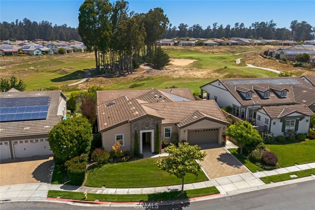 Resort living never looked so good! This Avila home will absolutely captivate you - it’s located on a beautiful cul-de-sac with a sweeping view of the golf course and soaring eucalyptus trees. This gorgeous 2,565 sq. ft. home has 3 bedrooms, 3 full bathrooms, plus a den and dining room, featuring luxurious engineered wood floors and beautifully-crafted crown molding throughout. Built for entertaining, you’ll fall in love with the kitchen - it’s well-equipped with a JennAir stainless steel wall oven, gas cooktop, two granite topped islands (one for prep, one for dining with modern globe pendant lighting), rich raised panel maple cabinetry, and a large pantry. Directly across is the dining room, which was created by enclosing the outdoor courtyard - the skylight makes it extra bright and sunny, and adds an abundance of natural light throughout the main living area, including the great room, which features a fireplace with custom mantel, flanked by built-in display cabinets and surrounded by spectacular golf course views. Head outside to the backyard with an expansive covered patio, low-maintenance artificial turf, paved pathways, lush trees and shrubs - it’s the perfect spot to relax and enjoy watching the golfers. Head inside to your master suite - a spacious bedroom with dedicated sitting area, direct patio access and two walk-in closets separated with built-in linen storage. The spa-like master bath features a large tiled shower with frameless glass enclosure, a garden tub, and separate dual sinks. Your guests will be equally as comfortable up front with two spacious bedrooms (one with en-suite bath, the other with custom tile floors and a full bath right next door). Additionally, there’s a den (which could be an office), laundry with sink and storage, 3-car tandem garage with showroom epoxy floors, plenty of built-in storage cabinets, and a screened door with welcoming custom light fixture at the front entry. Best of all, this delightful home is located in Trilogy with incredible resort-style amenities, including Adelina’s Bistro and Sandalwood Spa. This gorgeous home won’t last long - contact us today for a showing.