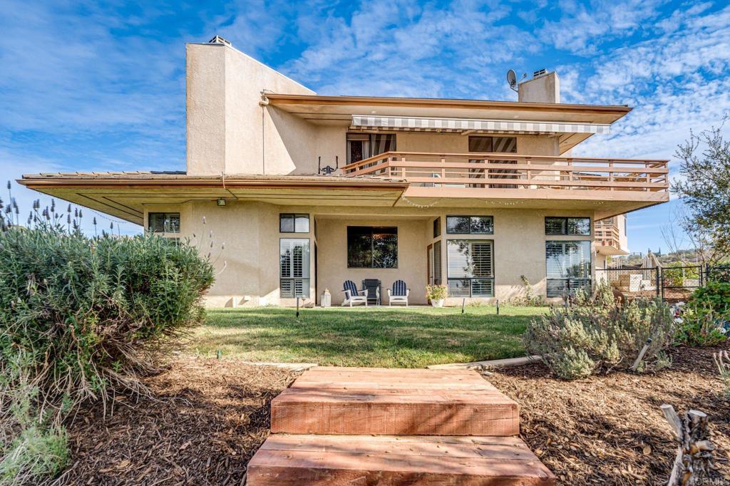 The architecture and design of this home were inspired by Frank Lloyd Wright, from the moment you walk thru the large pivot door to the winding hall upstairs that provides privacy to the master suite. There are no square rooms in this house! There is also leased Solar to help keep costs down! This Custom 4 bedroom home sits high on a hill on this 2.25 acre corner lot, just across from Hang Glider Hill, with Spectacular views in all directions! The house sits on the property perfectly to enjoy the sunrise in the kitchen and bathrooms and the sunsets in the living area and master suite balcony. In addition, the balcony on the east side of the house is the perfect place to enjoy a cup of coffee and watch the sun come up and the firepit on the west side is the best place to enjoy a perfect sunset. There is a vegetable and herb garden ready, fruit trees and grapevines. The front yard is an oasis of cactus and natural native plants that have beautiful flowers when in season. There are also 3 fish/lily ponds which have path ways and accent lighting for you to relax & enjoy. This is a one-of-a-kind home that offers as many possibilities as your heart desires. Hang Gliders Paradise!!!