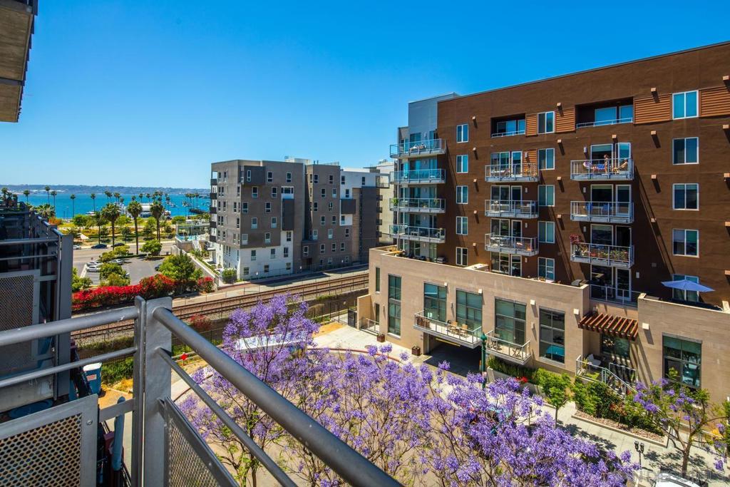 This spectacular designer-crafted 2-story loft in Little Italy is a must see! Enjoy your morning coffee and fabulous sunsets over San Diego Bay from the balcony. The great room features concrete walls, voluminous 17' ceilings and massive walls of glass that create a natural light and bright space to entertain. The eat-in kitchen has crisp white cabinetry, sleek quartz counters and stainless steel appliances. Amazing location close to Waterfront Park, Portside Pier, numerous cafes and fabulous fine dining. Hop on the trolley to catch a game at Petco Park or take a train up the coast for the weekend! In-unit laundry and 2 secure parking spaces are included. Common areas at Doma are undergoing renovations and will be like new very soon. Style, location and function make this space shine. Complex Features: ,, Equipment: Dryer,Fire Sprinklers,Garage Door Opener, Range/Oven, Washer Sewer: Sewer Connected Topography: LL