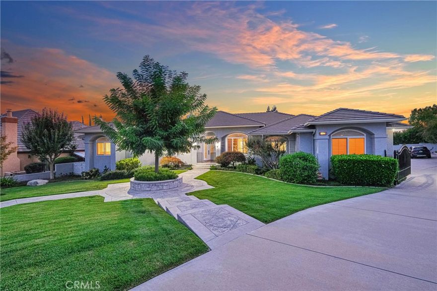 Nestled within the prestigious enclave of San Antonio Heights, this exquisite custom-built estate offers privacy and space on a sprawling lot of over half an acre. Meticulous craftsmanship and thoughtful design are evident throughout the home's expansive single-story layout, which is introduced by remarkable curb appeal and grounds designed for grand-scale entertaining.



An atmosphere of refined elegance greets you, characterized by high ceilings, rich wood flooring, and elegant crown moulding. The heart of the home is a magnificent great room that seamlessly integrates a gourmet kitchen, a spacious dining area, and a welcoming family room with a fireplace. The kitchen is a chef's dream, appointed with top-of-the-line stainless steel appliances, a double oven, and a large center island. Adjacent to this living space is a versatile bonus game room, complete with a wet bar and beamed ceilings.



The private accommodations are equally impressive, featuring a luxurious master suite that is a serene retreat. It boasts a jetted tub, a walk-in steam shower, and a substantial walk-in closet with custom cabinetry. Three additional generously sized bedrooms, one with a private exterior entrance perfect for a home gym or studio, and a handsome office with built-in cabinetry complete the thoughtful floor plan. The residence is also equipped with modern conveniences like a fully paid-off solar system, dual A/C units, and a central vacuum.



For the automotive enthusiast, the property features an extraordinary six-car garage equipped with epoxy flooring. The expansive grounds provide abundant parking for an RV, boat, and other recreational vehicles. The beautifully landscaped backyard offers a large covered patio for alfresco dining and relaxation, complemented by a separate area flourishing with mature fruit trees. This remarkable estate masterfully blends sophisticated design with exceptional amenities for an elevated lifestyle.