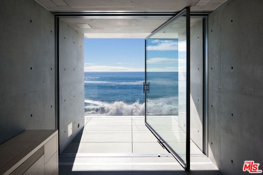 An architectural tour de force and only one of the few private homes in the United States designed by the renowned Pritzker Prize-winning Japanese architect, Tadao Ando. Best known for his minimalist structures and his assured use of reinforced concrete, Ando's trademark design of "smooth-as-silk" concrete is wholly present in the structure and surface of the home. Constructed of approximately 1,200 tons of concrete, 200 tons of steel reinforcement, and 12 massive pylons driven more than 60 feet into the sand with AD100 architecture firm Marmol Radziner acting as executive architect and general contractor, the structure is an everlasting beacon of permanence on California's coastline. Natural light is used creatively throughout the space, another signature of Ando, to manipulate a warm feeling throughout the building and harmonize with its natural surroundings. The home spans +/- 4,000 sq. ft. of interior space and approximately 1,500 sq. ft. of outdoor decks with ocean views from every room. Currently all interior finishes have been removed from the property, and work is needed to either restore or reimagine the interiors. Thoughtfully located on the prestigious and quiet Malibu Road, with easy access and close proximity to the finest restaurants, shopping, and entertainment in all of Malibu. An exceedingly rare architectural achievement that should be seen as a masterful work of art, rather than just a residence.