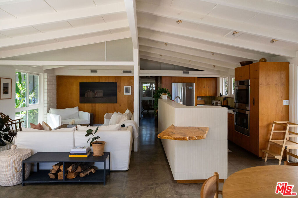 Welcome to this beautifully updated 1954 Cliff May Rancho in the coveted Rancho Estates neighborhood. This midcentury modern gem blends vintage character with thoughtful modern upgrades and includes your own private heated saltwater pool.Step inside to nearly 1,400 square feet of open-concept living. Polished concrete floors, original birch paneling, and clean architectural lines create an effortless blend of warmth and style. The kitchen features high-end appliances, a breakfast bar, and French doors that open to multiple patios perfect for entertaining or quiet mornings. This 3-bedroom, 2-bathroom home offers: Floor-to-ceiling windows and classic Cliff May indoor-outdoor flow. Central heating and air conditioning. Updated systems throughout. Professionally landscaped backyard with privacy fencing. Heated saltwater pool. Multiple patio areas for lounging, dining, or working from home. Located on a tree-lined street just blocks from 800-acre El Dorado Park and Nature Center, this home offers serene suburban living with convenient access to both LA and Orange County. Rancho Estates is known for its strong sense of community and architectural charm. Professionally managed by Locals Property Group.
