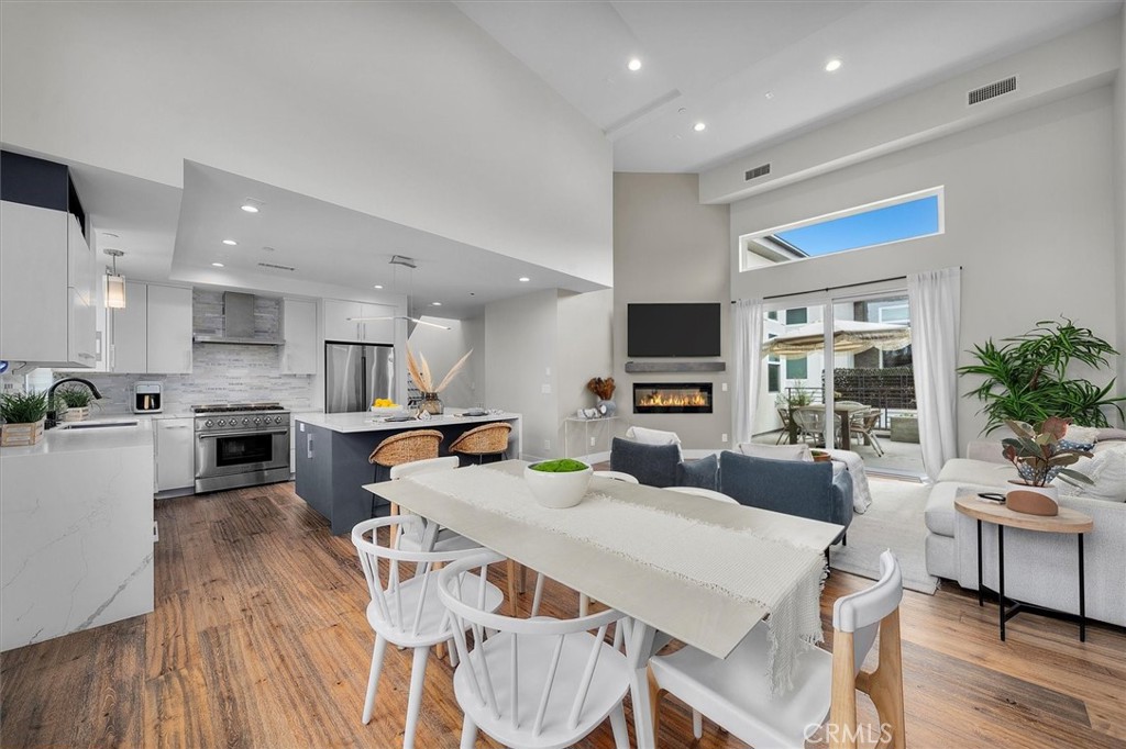 Discover refined coastal living in this stunning 2019-built residence at 2713 Carnegie #B. Designed with elegance and comfort in mind, this home offers five spacious bedrooms and four bathrooms across 3 floors and 2,207 square feet. The white oak floors, gas fireplace, light colors, and soaring vaulted ceilings create a bright, airy atmosphere filled with natural light, inviting you to unwind and entertain with ease. The chef’s kitchen is a culinary masterpiece, featuring high-end appliances, including a Thor gas range and a wine fridge that is seamlessly integrated into the kitchen island—perfect for hosting intimate gatherings or family dinners. A private balcony extends out from the open living room creating an incredible indoor/outdoor environment. Additionally, you can enjoy your own private rooftop patio, an ideal retreat to enjoy breathtaking sunsets and ocean breezes. You are centrally located only minutes away from the best of Manhattan Beach, Hermosa Beach, and Redondo Beach. This home offers the perfect blend of seaside serenity and urban convenience allowing you to live the South Bay lifestyle without sacrificing comfort and space.