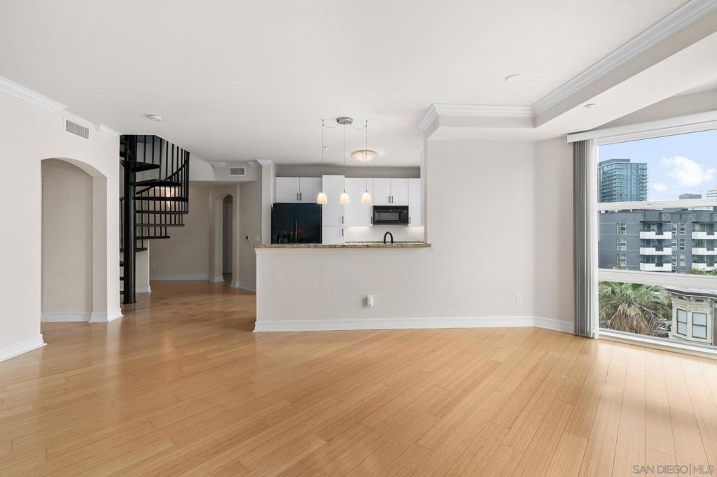 RARE CORNER UNIT WITH PRIVATE ROOFTOP!! Discover urban living at its finest in this stunning 2 bed, 2 bath top-floor corner unit located in the heart of San Diego’s desirable East Village. Floor-to-ceiling windows flood the space with natural light, highlighting the open floor plan. Enjoy panoramic north-facing city views from your expansive private rooftop deck, one of the largest in the complex! The space is perfect for relaxing or entertaining. Other notable features include a large primary bedroom walk in closet, in unit laundry, two rare side-by-side parking spaces and private storages, offering convenience and peace of mind. Just steps from vibrant restaurants, bars, and the iconic Petco Park, this home places you in the center of it all. Don't miss this opportunity to own a truly unique space in one of Downtown San Diego's most sought-after neighborhoods!