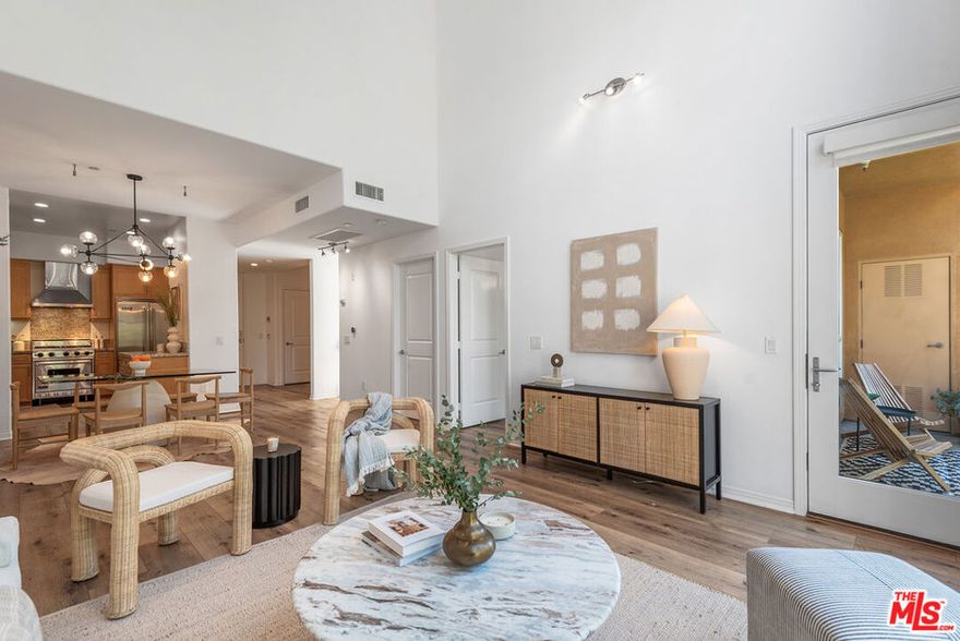 Whoever said size doesn't matter clearly never lived in 2,300 sq ft of light-filled luxury. This rare top-floor corner residence spans two levels, with soaring ceilings and sweeping east-to-west views, and embodies the ultimate in luxury, scale, and comfort. The main level is designed for entertaining, with nearly 20-foot ceilings, rich wood floors, a decorative fireplace, and custom window treatments. The great room anchors the layout, while a separate den/office adds versatility. A guest bedroom/office with access to the balcony and bathroom completes the downstairs. Upstairs, retreat to an enormous primary suite with oversized closets, spa-style bath (soaking tub, enclosed shower, dual vanities, private toilet room), and direct access to a private rooftop deck. An additional bedroom with a full bath, upstairs laundry, adds convenience and flexibility. Meticulously maintained, this residence includes exceptional closet/storage space, two premier side-by-side parking spaces, and guest parking. Indigo's resort-style amenities include a gym, spa/sauna, meeting room, and BBQ courtyard. All this in the heart of Silicon Beach and just moments from Gelson's, top restaurants, boutique shops, dine-in theaters, Abbot Kinney, Venice Beach, freeways, and LAX.