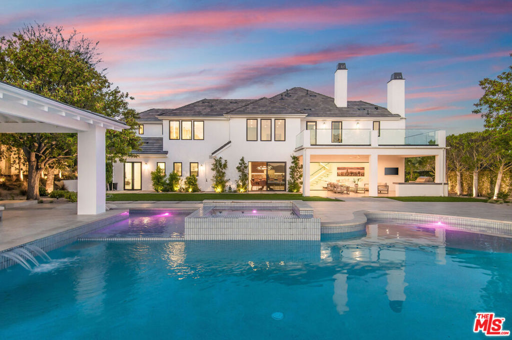 The Pinnacle of Calabasas modern luxury where no expense has been spared. Prepare to be mesmerized by this immaculately reimagined view estate, a stunning embodiment of tasteful modernism infused with sophistication. Every detail of this residence has been meticulously crafted to perfection, offering a lifestyle of unparalleled opulence.Step inside to discover all-new flooring that exudes elegance and sets the stage for the grandeur that awaits. The heart of the home, the kitchen, boasts Miele custom built-ins, promising a culinary experience beyond compare. Experience the seamless integration of indoor and outdoor living with new floor-to-ceiling pocket doors and screens that effortlessly disappear into the walls, inviting in the breathtaking vistas of the surrounding landscape.Entertainment reaches new heights with an extraordinary home theater featuring 8K projection, ensuring an immersive cinematic experience like no other. Admire the sleek lines of the all-new modern iron frame doors and windows that adorn the entire property, allowing natural light to cascade in and illuminate every corner.Indulge in the epitome of relaxation in the updated bathroom suites, adorned with modern finishes, floor-to-ceiling mirrors, heated floors and ambient lighting. The primary suite is a sanctuary unto itself, offering magnificent views and ultimate privacy. Unwind in the luxurious primary spa, complete with an extended shower featuring steam capabilities and two incredible walk-in closets custom-tailored to meet your every need.Venture outside to the resort-inspired backyard oasis, where an infinity pool, spa, and baja shelf beckon you to soak up the California sun. Retreat to the covered casita with a fireplace, perfect for alfresco dining or cozy gatherings under the stars.No stone has been left unturned in this impeccable masterpiece of an estate. Welcome home to a world where luxury knows no bounds, and every moment is a testament to refined living.