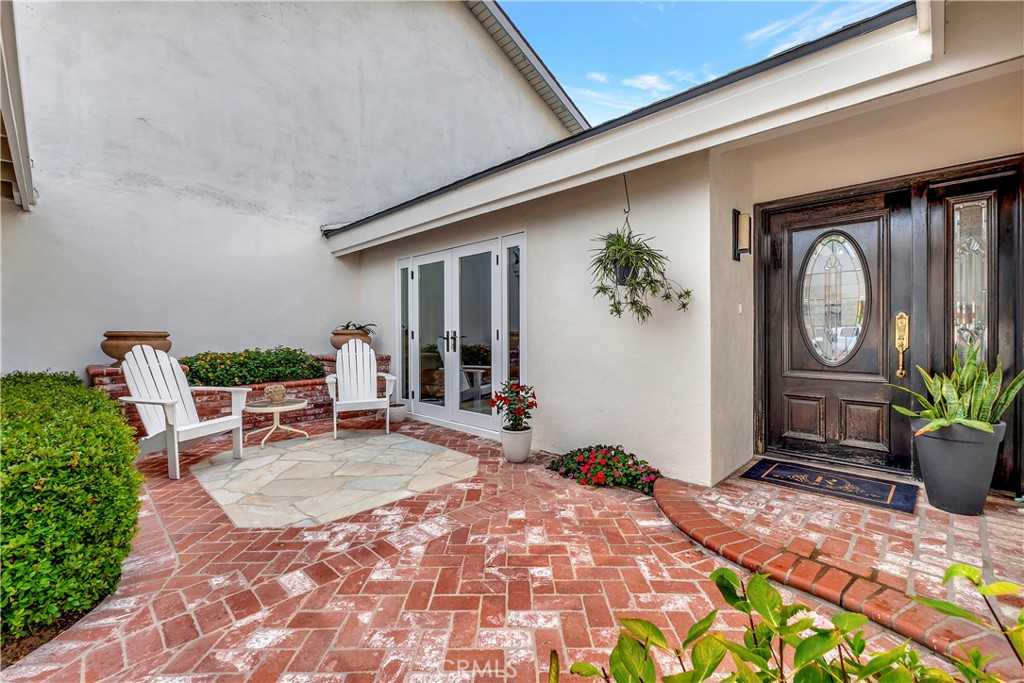 Step into the comfort of a meticulously maintained single-family residence, where elegance meets warmth, style, and timeless charm.
From the moment you approach, the wood mahogany front door hints at the quality and details invested in this home and opens to spaces that feel both refined and welcoming, while french doors invite you onto a front patio lined with classic red brick and surrounded by greenery. See yourself beginning your days sipping coffee as sunlight filters through the leaves, or in the evenings unwinding with a glass of wine in your private outdoor haven.
Inside, soaring high ceilings amplify the sense of space, and a fireplace offers comfort on cooler California nights. The central living area is seamlessly connected to the meals space, creating the perfect environment for everything from lively get-togethers to quiet evenings at home. The heart of the home, the kitchen, is outfitted with sophisticated custom cabinetry and the open layout ensures that preparing meals feels less like a chore.
Details matter in this home and each space speaks of thoughtful care and pride of ownership. Wainscoting in the guest bathroom and den adds a touch of elegance, creating an inviting atmosphere throughout, while fresh paint on the exterior of the home (close to a year and half old) ensures the property looks as well-kept on the outside as it feels inside.
The outside awaits your private backyard, where you will discover paved walkways framing vibrant plants while creating a low-maintenance but lush retreat for gardening, relaxing, or hosting weekend barbecue grill-outs under the California sky.
Also, this home provides access to top-rated schools, including University High School, making it an excellent choice for those seeking quality education(rated an impressive 10/10 by GreatSchools.org).