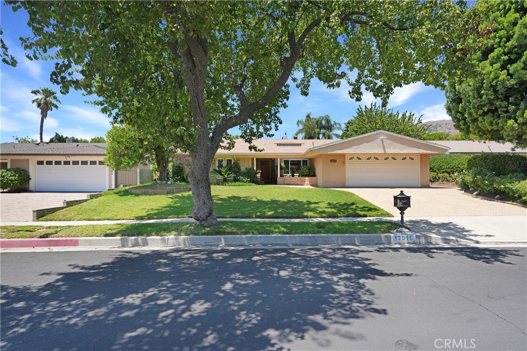 Welcome home to this wonderful single-story 5-bedroom/3-bathroom home nestled on a quiet tree-lined interior street in one of Granada Hills’ most desirable neighborhoods. As you step inside this bright and airy residence you’ll be amazed by the inviting living room with a fireplace that adds warmth to your gatherings. The home has a natural flow from the living room and dining room to the family room and kitchen. The kitchen is complete with granite counters and a convenient breakfast bar. Store your ingredients in the walk-in pantry. For those special occasions, there's a formal dining room that's perfect for hosting guests with direct access to the kitchen. The primary bedroom features an en-suite with two walk-in closets. This property offers modern comforts, including an HVAC system to keep you comfortable year-round and an extra large 2-car garage. Step outside to your wonderful front and backyard areas. You'll fall in love with the tranquil setting in the backyard, with a covered cement patio, large grass area with lush plants and fruit trees. The location of this home is unbeatable, with easy access to Bee Canyon and O’Melveny Parks, offering hiking trails and outdoor adventures right at your doorstep. You'll also enjoy the convenience of being in a highly regarded school district, including the award-winning Van Gogh Elementary School and Robert Frost Middle School. Conveniently located close to freeways, dining, shopping and more! Original owners, first time on the market-bring your design style and make it yours!