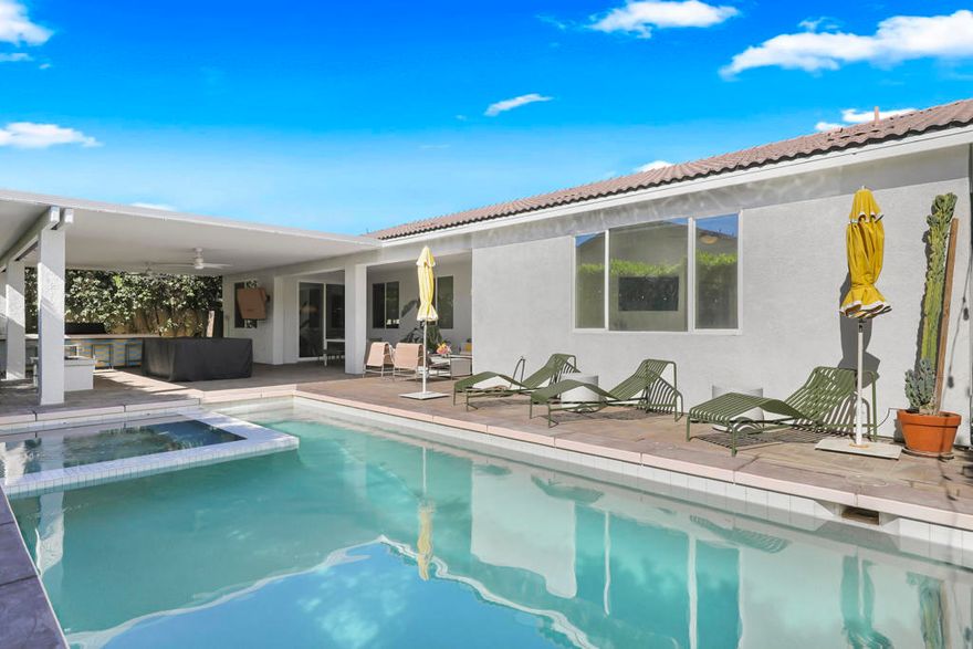 This home has been refreshed with updates that make it comfortable, welcoming, and ready to enjoy. It now offers five full-size bedrooms, plus a den that has been enclosed to serve as a sixth bedroom or flexible-use space. A private casita-style suite--with its own entrance and ensuite bath--provides an ideal setup for guests or anyone who prefers a bit more privacy. The backyard is a true highlight, redesigned for year-round enjoyment. Updates include a refinished pool, an upgraded pergola, and an expanded outdoor kitchen and bar. A generous covered patio spans the length of the home and includes LED lighting, ceiling fans, a spacious built-in island with bar seating, a mini-fridge, and a 40-inch stainless steel natural-gas grill. Additional features include a dining area, lounge with a mounted television, custom natural-gas stone fire pit, 8-foot pool table, and a fully automated heated pool and spa with LED lighting. Inside, the open-concept layout connects the living room, kitchen, and dining area for easy everyday living and entertaining. The kitchen features a large island and custom sage-toned cabinetry, designed with the home cook in mind. The open layout ensures everyone stays connected whether preparing meals, dining, or relaxing. With five well-sized bedrooms--including the private casita-style suite with exterior access--and a large den/bedroom, the home offers generous accommodations for a wide range of needs. Created for comfort, style, and effortless entertaining, this property provides a private resort-like setting and captures the best of desert living, indoors and out.