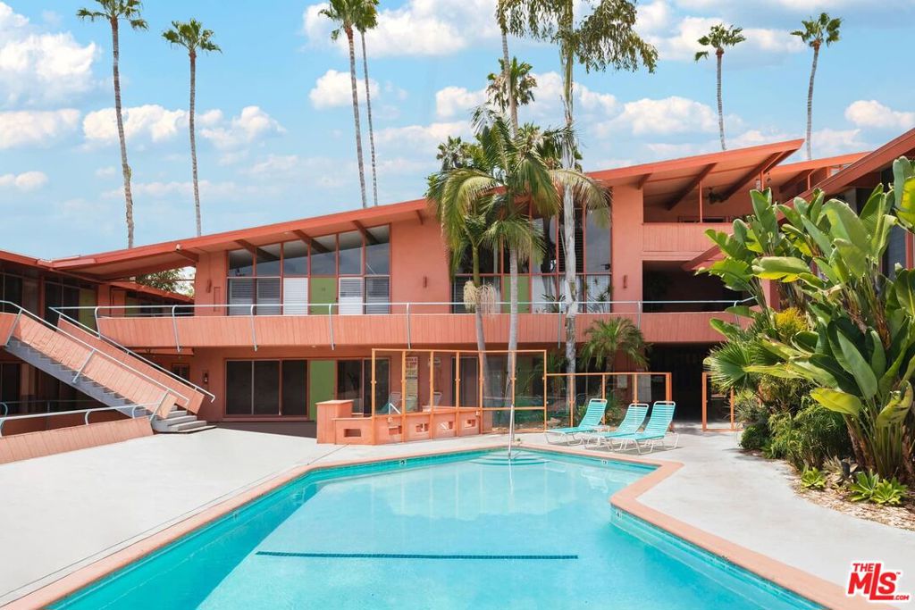 The iconic "Hollywood Riviera" is an architecturally significant West Hollywood treasure and designated landmark. It was built in 1954 by renowned architect, Edward H. Fickett. This charming first floor unit with hardwood flooring and large windows throughout this light and bright open floor plan offers a recently renovated kitchen, restoring all the original mid-century cabinetry serving the dinning/living. Step out to the large private rear patio for indoor/outdoor entertaining. Walk out the front door to the resort-like, heated swimmers pool and sunning deck. The secured main building entry features lava rock and tropical plantings. Automated gated covered parking for 2 cars. On the Mills Act passing huge property tax savings to the buyer. Featured in films such as (Rush Hour, L.A. Stories + many more), TV shows, & commercials. Tree-lined street in best location - walk to Sunset's shops, entertainment and restaurant's. This is California living at it's finest!