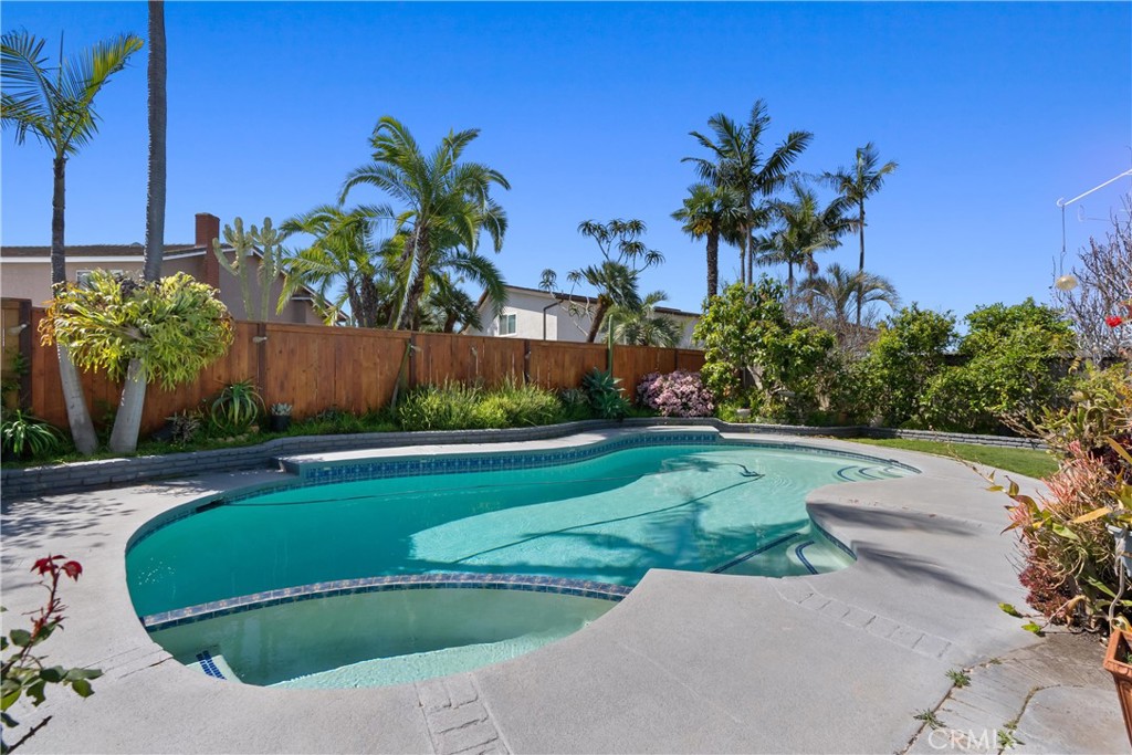 Summertime is here! School's out! Time to find your new home! And what better place to find it than in this desirable neighborhood in Huntington Beach. This spacious 4-bedroom, 2.5-bathroom home is located less than 3 miles from the beach, but you can always choose to stay home and enjoy your private backyard oasis featuring a pool, spa, and lots of outdoor space for hosting BBQ's with friends or simply unwinding after a long day. This well-maintained propery features a thoughtful layout, perfect for relaxing and entertaining. As you step inside, you'll be greeted by the bright and airy living spaces, highlighted by two inviting fireplaces - one in the living room and the other in the cozy family room. The heart of the home includes a spacious kitchen and dining area, perfect for family meals or gatherings with friends. For added convenience, the property also includes an inside laundry room, newer hot water heater and HVAC system. Close to Downtown Huntington Beach, Pacific City, great restaurants, shopping and parks. Also located within walking distance to William T. Newland Elementary School and surrounded by other award-winning schools. This home has been lovingly cared for and is waiting for you to add your personal touches. With so much potential and a prime location this is your chance to truly make this home your own. What are you waiting for?