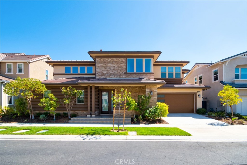 Nestled in the exclusive 24-hour guard-gated community of Altair Irvine, this stunning home offers 3 bedrooms, 2 full baths, 2 half baths, and a California room with a cozy fireplace. The spacious open-concept layout seamlessly connects the main living areas, while the California room—with its stackable slider doors—extends the living space outdoors, perfect for entertaining or relaxing. The home features a luxurious downstairs master suite and two additional bedrooms upstairs.Residents of Altair enjoy access to resort-style amenities, including sparkling pools and spas, a clubhouse, sports courts, playgrounds, and scenic walking trails. Conveniently located within the award-winning Irvine Unified School District, this home provides easy access to major freeways, shopping, and dining.