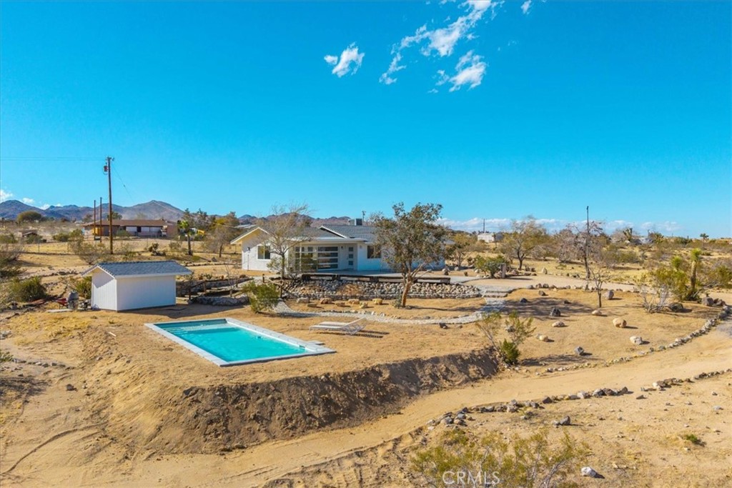 Come and make this charming Yucca Valley home with sweeping desert views your own.
Perched on 2.02 acres of land, this delightful 3-bedroom, 2-bathroom home offers the perfect blend of seclusion and convenience. Built in 1985, this 988-square-foot property boasts an open-concept design, creating a bright and airy living space ideal for both relaxation and entertaining.
Enjoy stunning, sweeping desert views right from your own yard while lounging by the sparkling inground pool. The property is fully fenced, providing privacy and a peaceful oasis. With desert landscaping, the home harmonizes with the natural surroundings, giving you that quintessential desert retreat feel.
Conveniently located near all the local amenities in Flamingo Heights, this home is the perfect getaway or forever home for those seeking a serene lifestyle with easy access to nearby attractions and conveniences. Recent updates include a new garage door, paint, flooring, and pool enhancing the curb appeal and functionality.
Whether you're looking for a vacation home or a full-time residence, this property offers the ultimate desert living experience. Seclusion, comfort, and breathtaking views await you. Don't miss the opportunity to make this your own!
