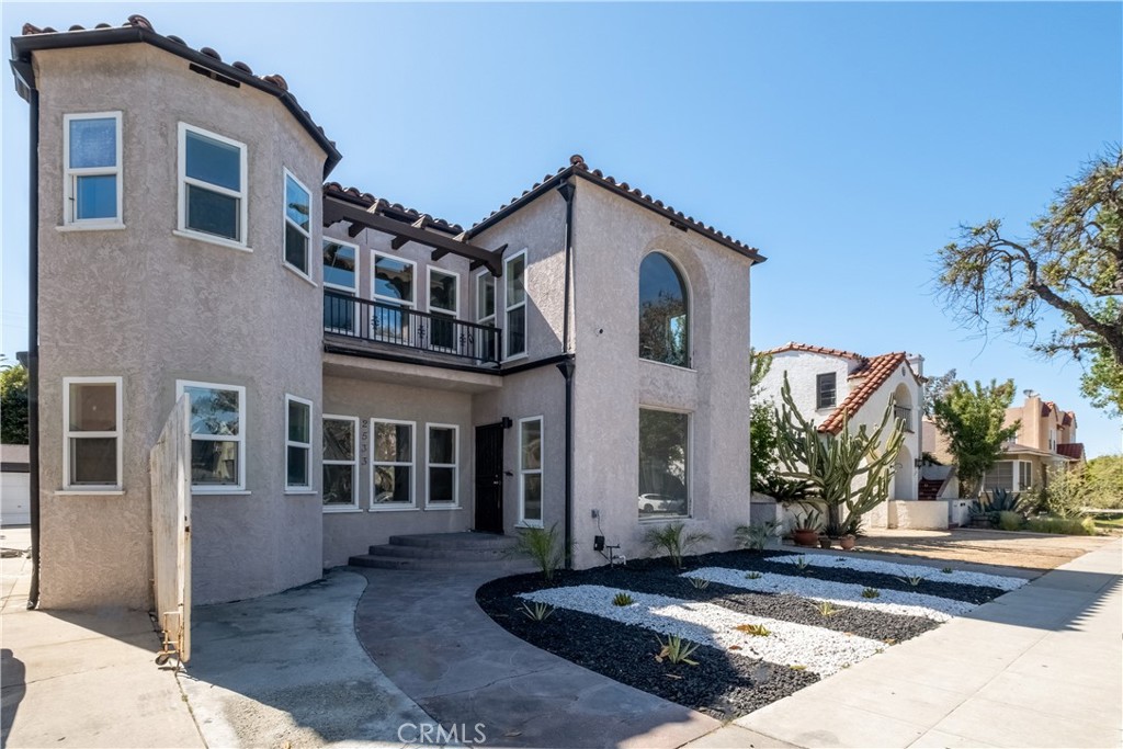 Brand-new construction meets vintage charm in this fully occupied, income-producing Long Beach fourplex bringing in $12,300/month. This fully upgraded four-unit property blends character and modern comfort in a highly accessible Long Beach location. The front unit showcases a vibrant and inviting design with arched doorways, original hardwood flooring, and a bright, open layout. The updated kitchen features bold turquoise shaker cabinets, quartz countertops, a mosaic tile backsplash, stainless steel appliances, and ample natural light. The bathroom offers spa-like finishes with marble-style tile, a soaking tub, a large walk-in shower with built-in niches, and a dual vanity with chrome fixtures. Bedrooms are spacious and airy, maintaining vintage charm while offering everyday functionality. The two rear units have been newly constructed and thoughtfully designed with vaulted ceilings, recessed lighting, and modern wood-style LVT flooring. Each includes an open-concept kitchen with white shaker cabinetry, quartz countertops, designer tile backsplashes, pendant lighting, and stainless steel appliances. Bathrooms are sleek and stylish with glass-enclosed showers, matte black hardware, and quartz-topped vanities. Additional features include mini split heating and cooling systems, modern ceiling fans, and French door access that enhances natural light and indoor-outdoor flow. Each unit enjoys a private entrance and has been finished with durable, low-maintenance materials ideal for rental income or multi-generational living. Located near shopping, schools, freeways, and public transit, this is a turnkey opportunity with both immediate income potential and long-term value.