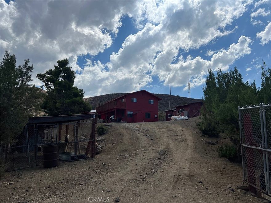 Private Gated Estate on 4.5 Acres with Mature Fruit Trees & Panoramic Hillside Views! Discover serenity and seclusion in this exclusive 4.5-acre gated compound nestled among rolling hills. This very private retreat features mature fruit trees, expansive open spaces, and breathtaking panoramic views. Ideal for sustainable living, the property is equipped with solar energy, offering both eco-conscious benefits and long-term savings. A rare opportunity to own a unique slice of paradise with room to grow, relax, or create your dream retreat.