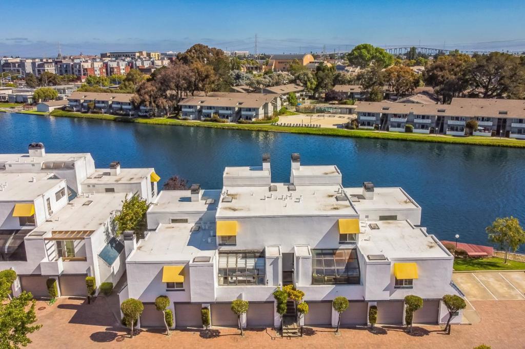 Seller to cover 1 year of HOA fees! Live the waterfront lifestyle in Lido Isle with this rare condo offering bright, airy interiors and stunning lagoon views from both sides. The open great room features a fireplace and a dining area that flows to a private balcony. A sun-filled family room with greenhouse windows frames the dock and water beyond. The updated kitchen boasts quartz counters, an electric oven/range, dishwasher, refrigerator, pantry/utility room, and hardwood floors. Recent upgrades include brand-new flooring throughout, recessed lighting, and temperature-regulating blinds in the sunroom. Additional enhancements include updated baths, plantation shutters, crown molding, and a skylight that floods the home with natural light. Upstairs, the primary suite captures sweeping water vistas, with a generous guest suite nearby. The upper-level laundry offers a washer, dryer, and 220V hookup. Resort-style amenities include a lagoon-side pool, spa, and clubhouse, plus a boat dock and storage for kayaks, paddleboards, windsurfers, and small sailboats. Conveniently located near top San MateoFoster City schools, parks, shopping, and Hwy 92/101, this move-in-ready home is impeccably maintained and designed for comfortcomplete with water views at every turn.